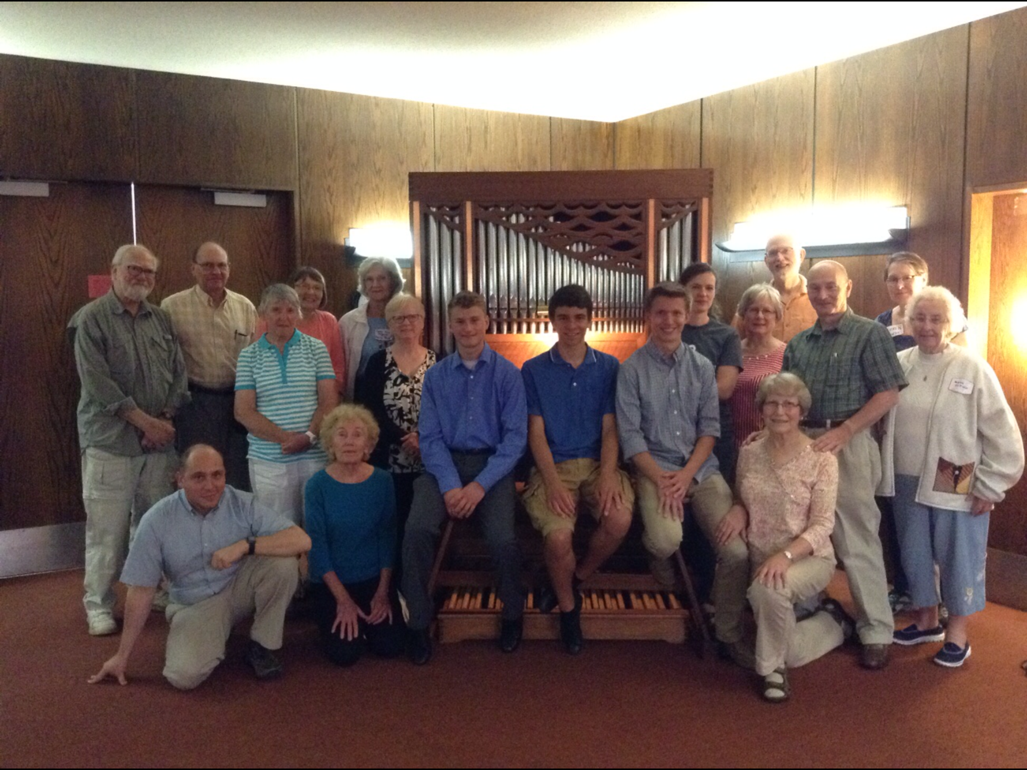 Parker MacIver Hinnenkamp shares the bench with fellow scholarship students Jace Jordan and Josh Peterson surrounded by members of the Arrowhead Chapter of the American Guild of Organists after a masterclass with Jesse Eschbach.
