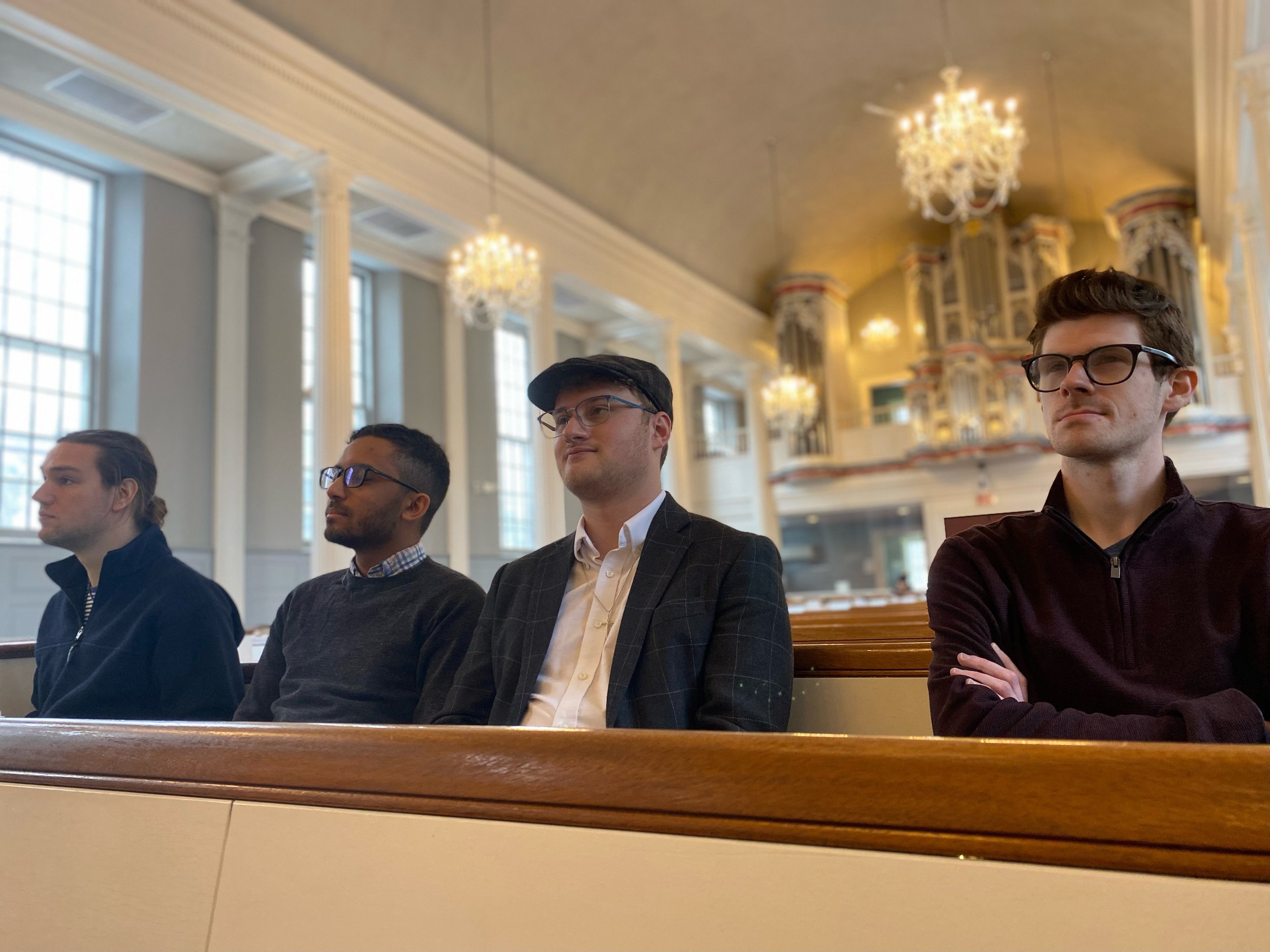 Parker MacIver Hinnenkamp listening to a recital in St. John's, Stamford, Connecticut, with colleagues and friends (from left) Andrew Earhart, Luke Staisiunas, and Nathan Peace.