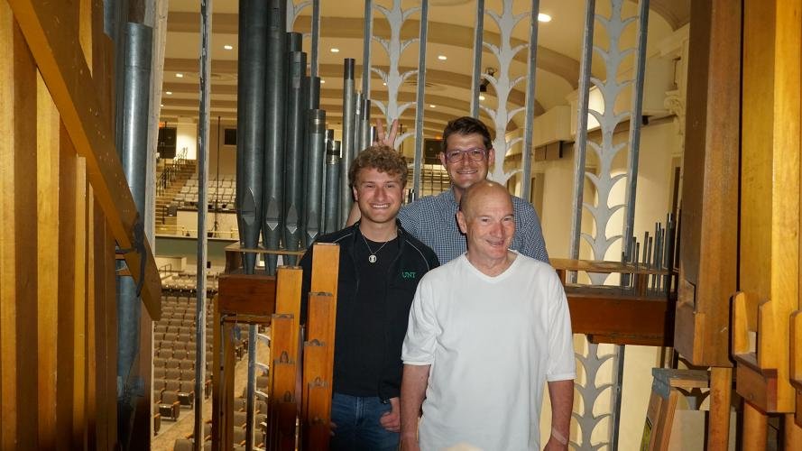 Parker MacIver Hinnenkamp with Hentus van Rooyen and Jesse Eschbach in the stage-left organ chamber of the Moller organ in UNT's Main Auditorium.