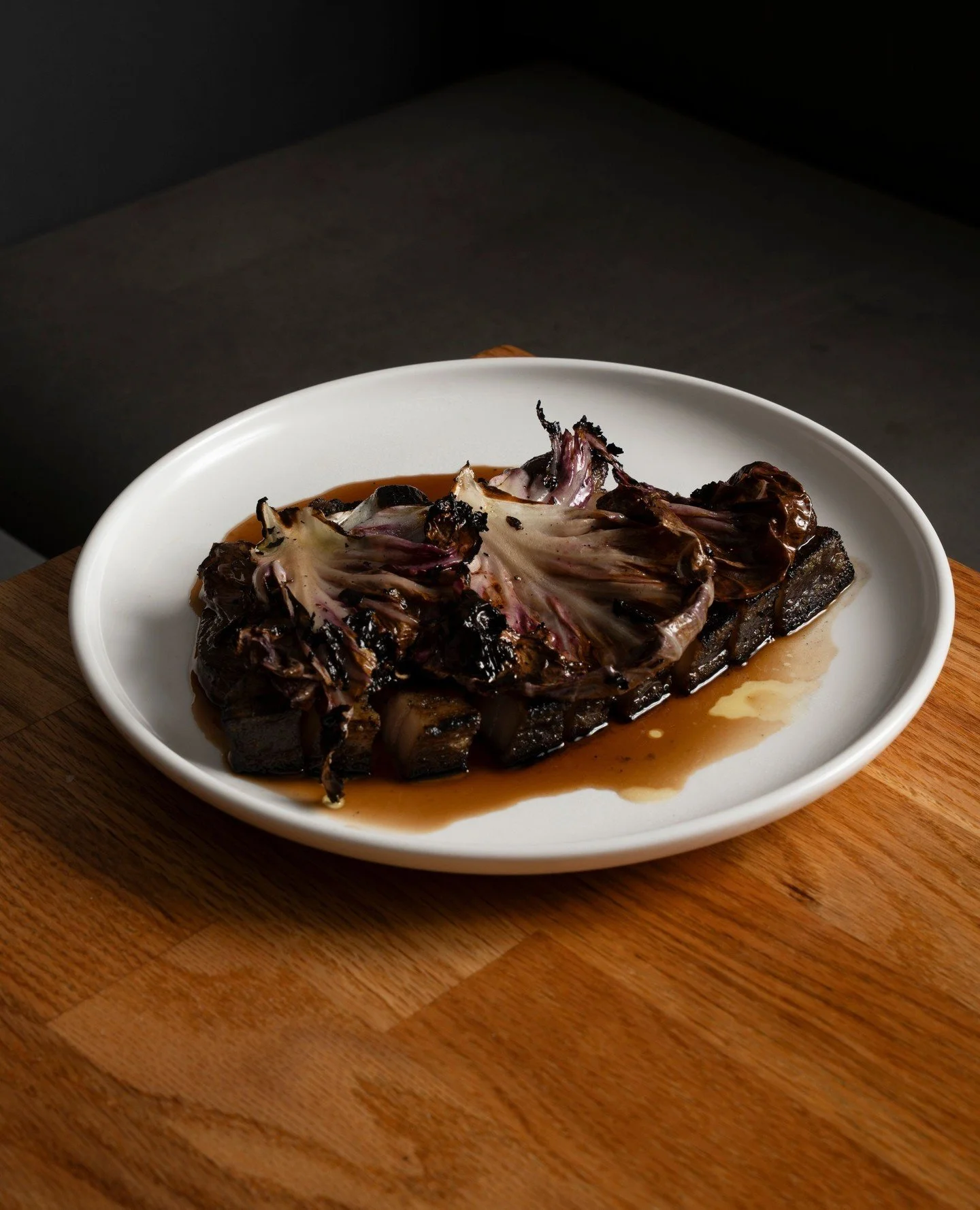 Pork chop, smoked apple sauce, grilled radicchio. A current grill hero.⁠
⁠
📷️ @joeybailey