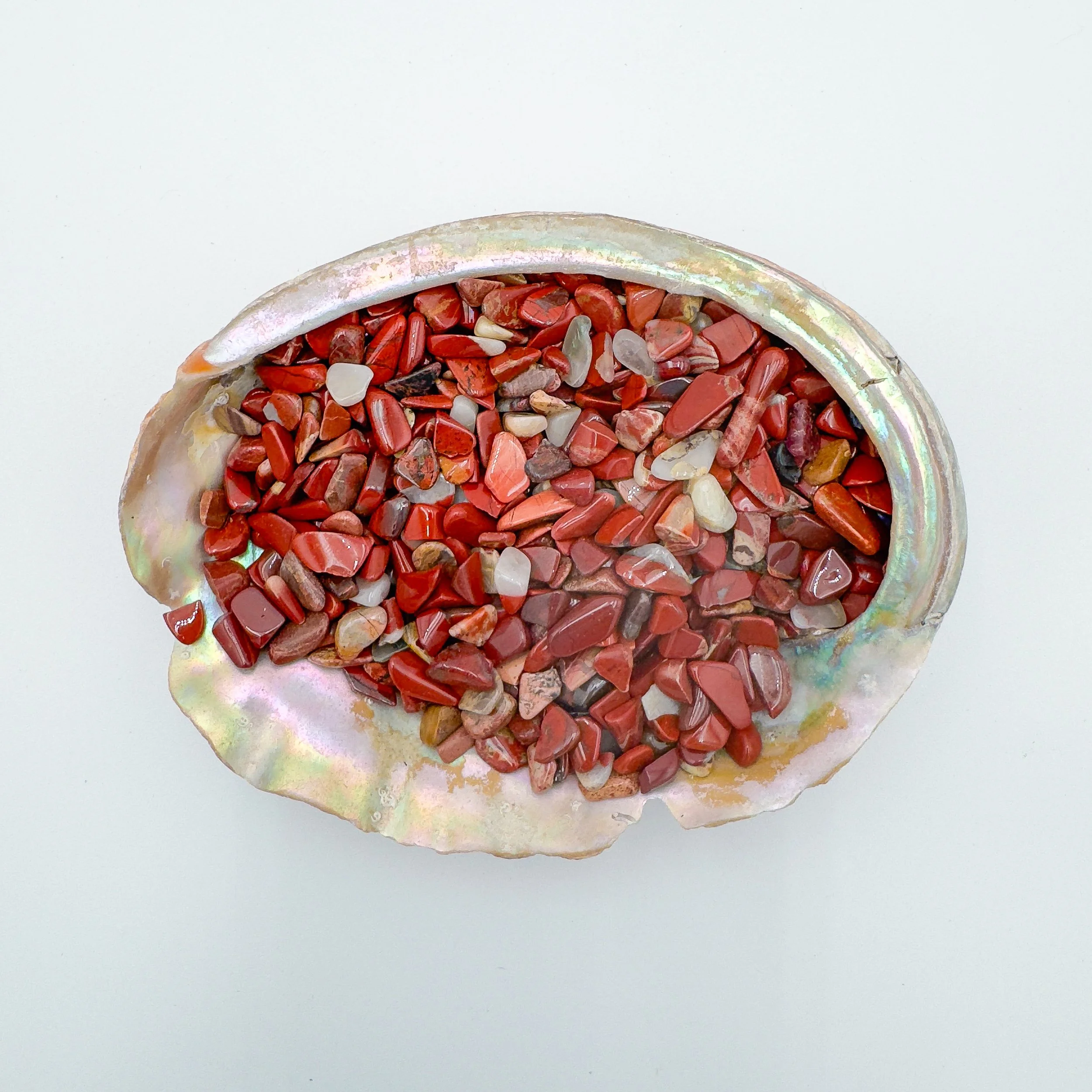 Red Jasper crystal chips in earthy deep red tones, polished and tumbled for use in jewelry design, candle décor, resin art, and grounding crystal work.