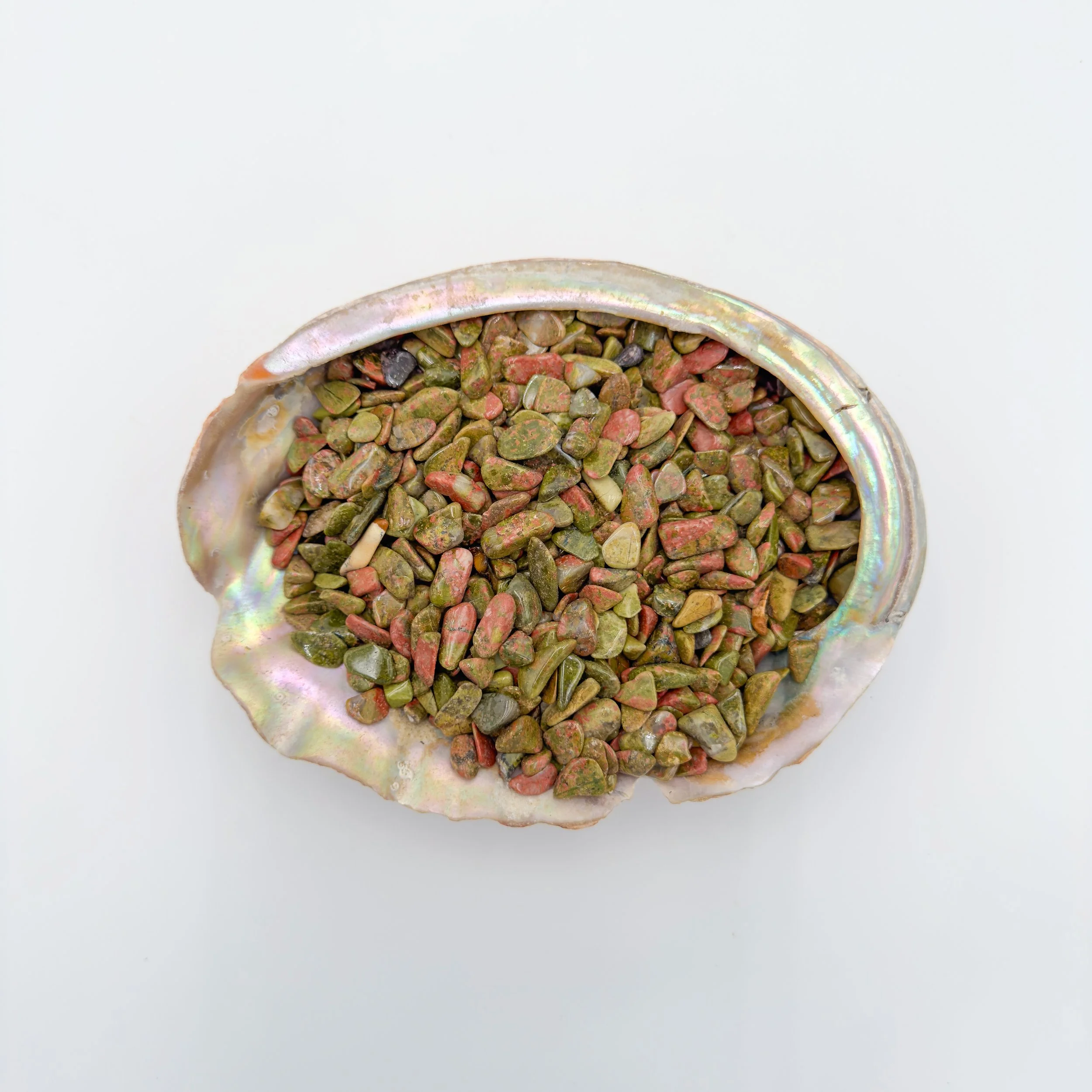 Unakite crystal chips in polished green and pink tones, displayed in bulk for use in crafts, jewelry design, meditation bowls, and home décor accents.