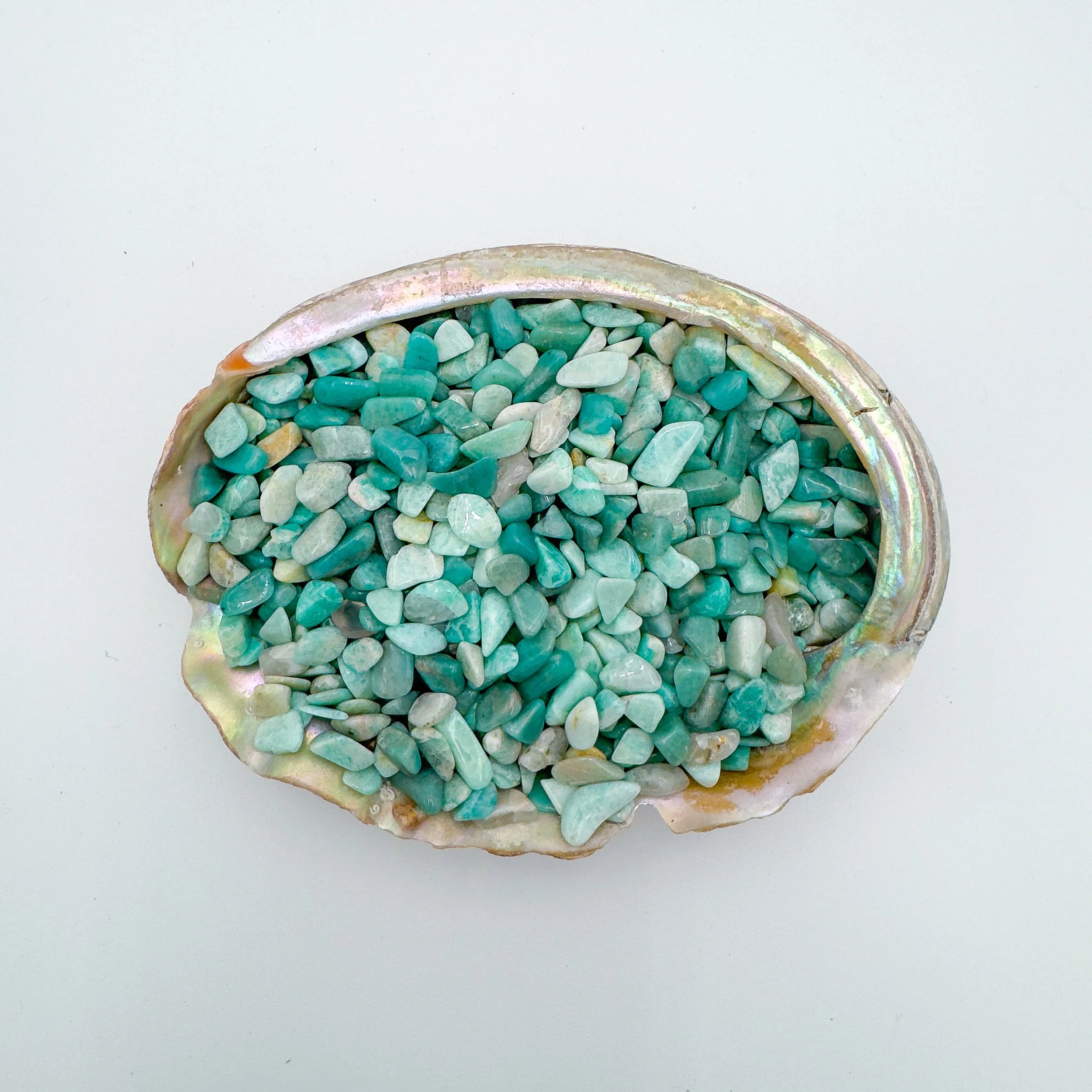 Bulk Amazonite crystal chips – polished tumbled aqua-green gemstone pieces, ideal for crafts, décor, jewelry making, meditation, and healing energy work.