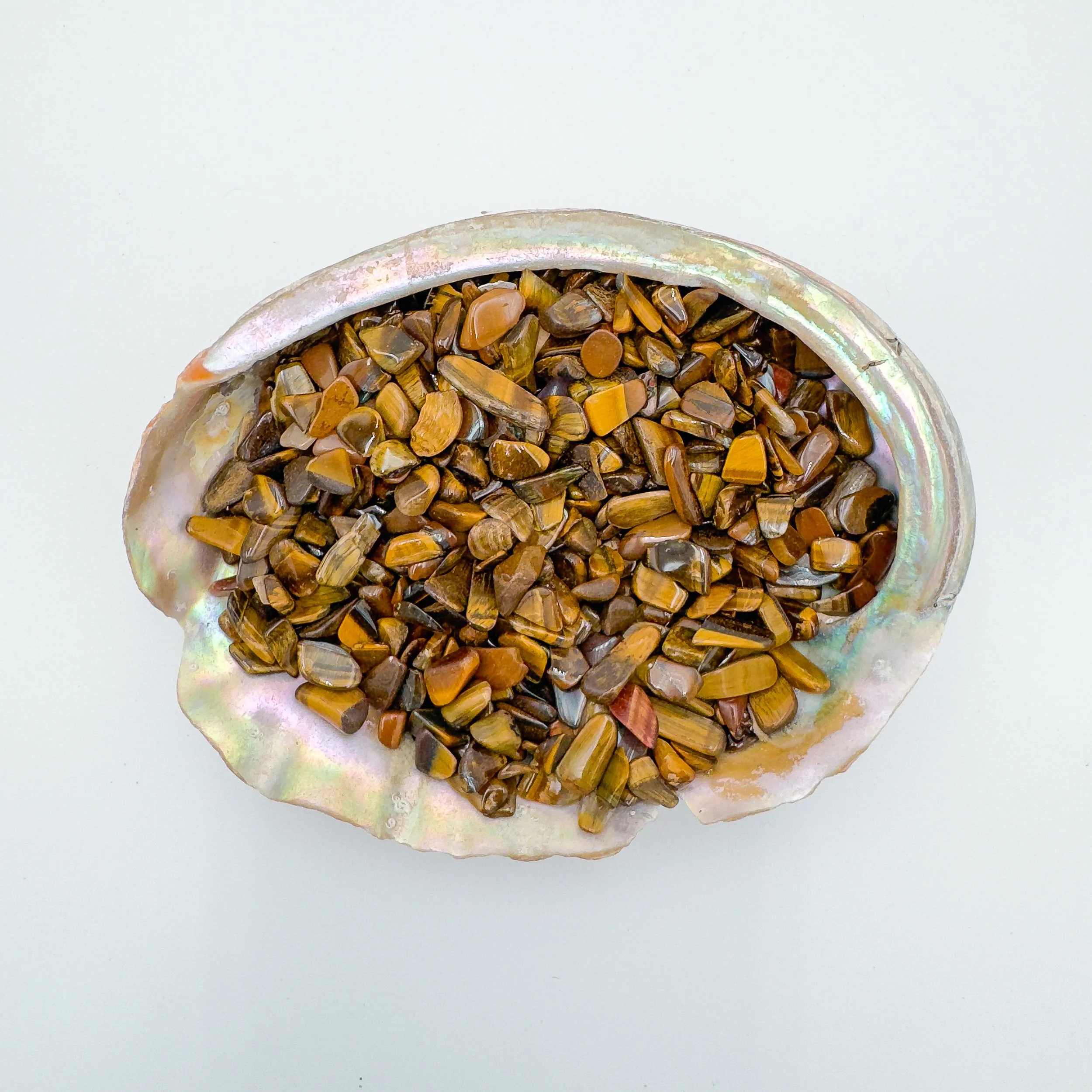 Tiger’s Eye crystal chips with golden brown chatoyancy, polished stones in bulk for wire wrapping, resin crafts, intention jars, and decorative bowls.