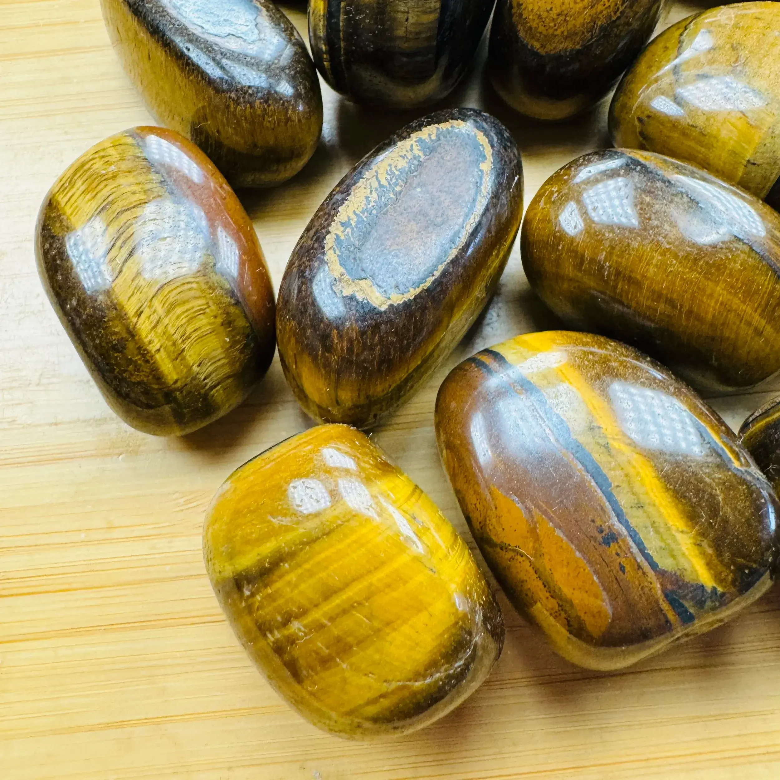 Tiger eye crystals ethically sourced, showing golden brown chatoyancy commonly associated with confidence, focus, and strength.