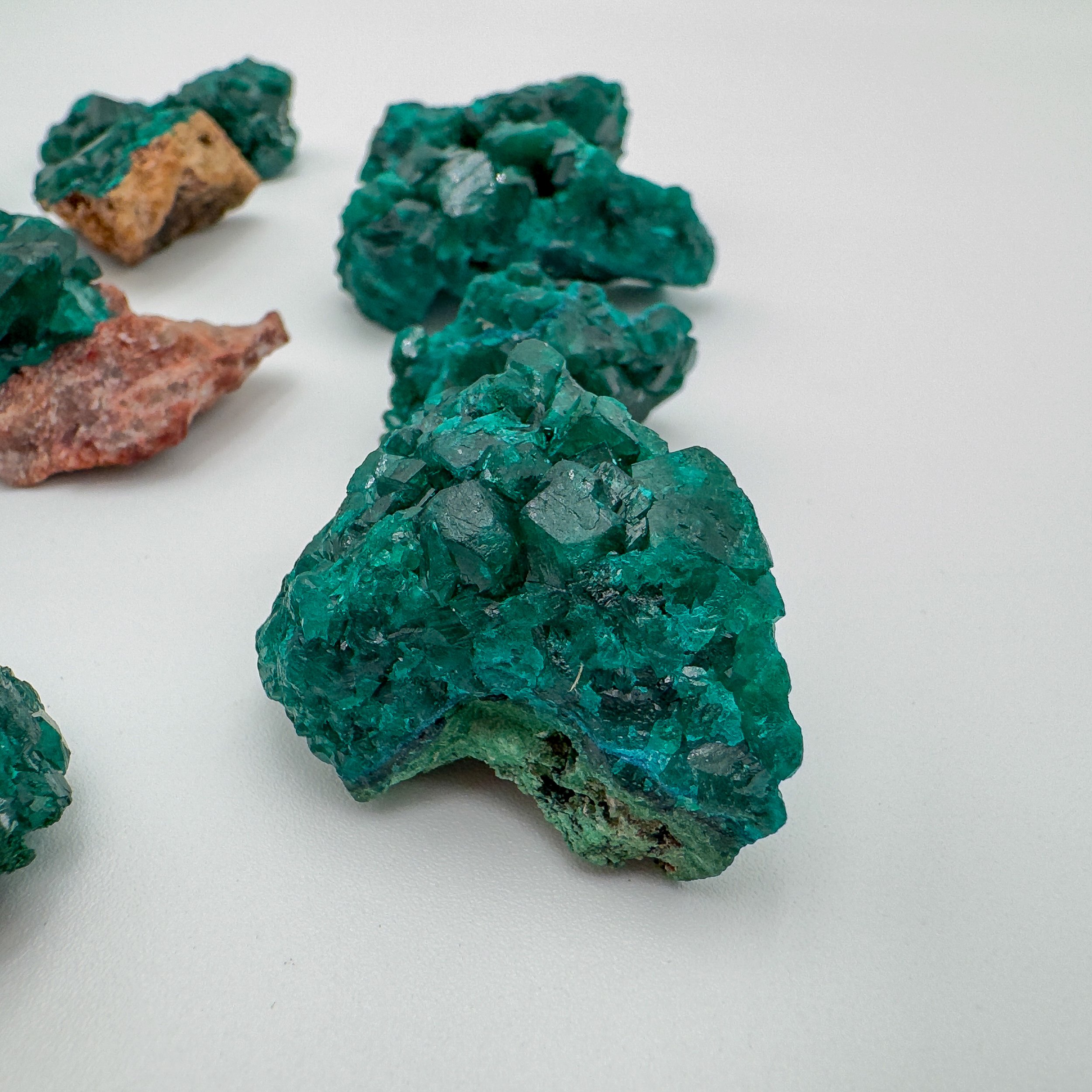 Close-up of a Dioptase crystal cluster with deep green prismatic formations.