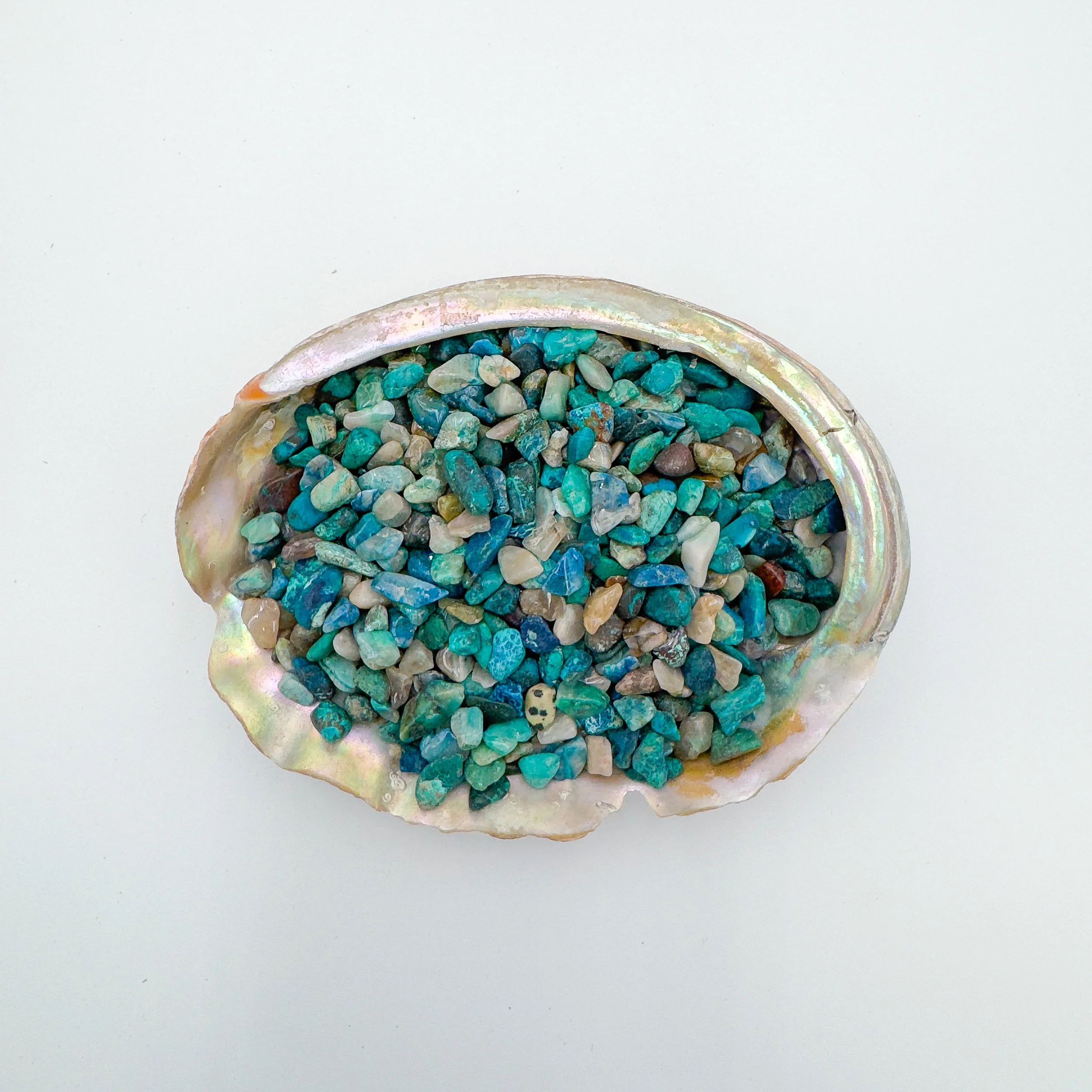 Polished Shattuckite chips in vibrant blue and teal shades, shown in bulk for jewelry making, crystal healing, décor, and craft projects.