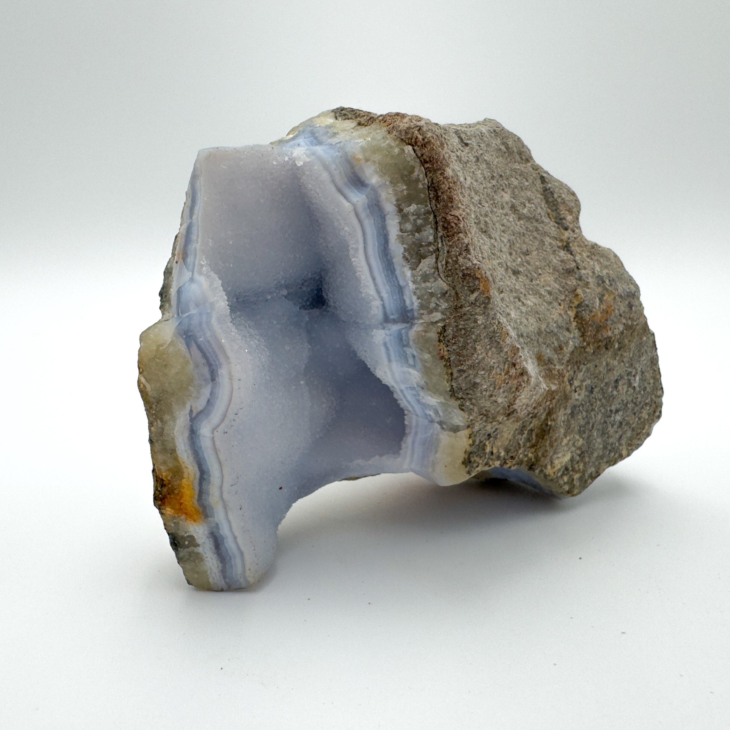 One-of-a-kind Blue Lace Agate geode showcasing layered banding, a raw exterior, and vibrant blue coloration.