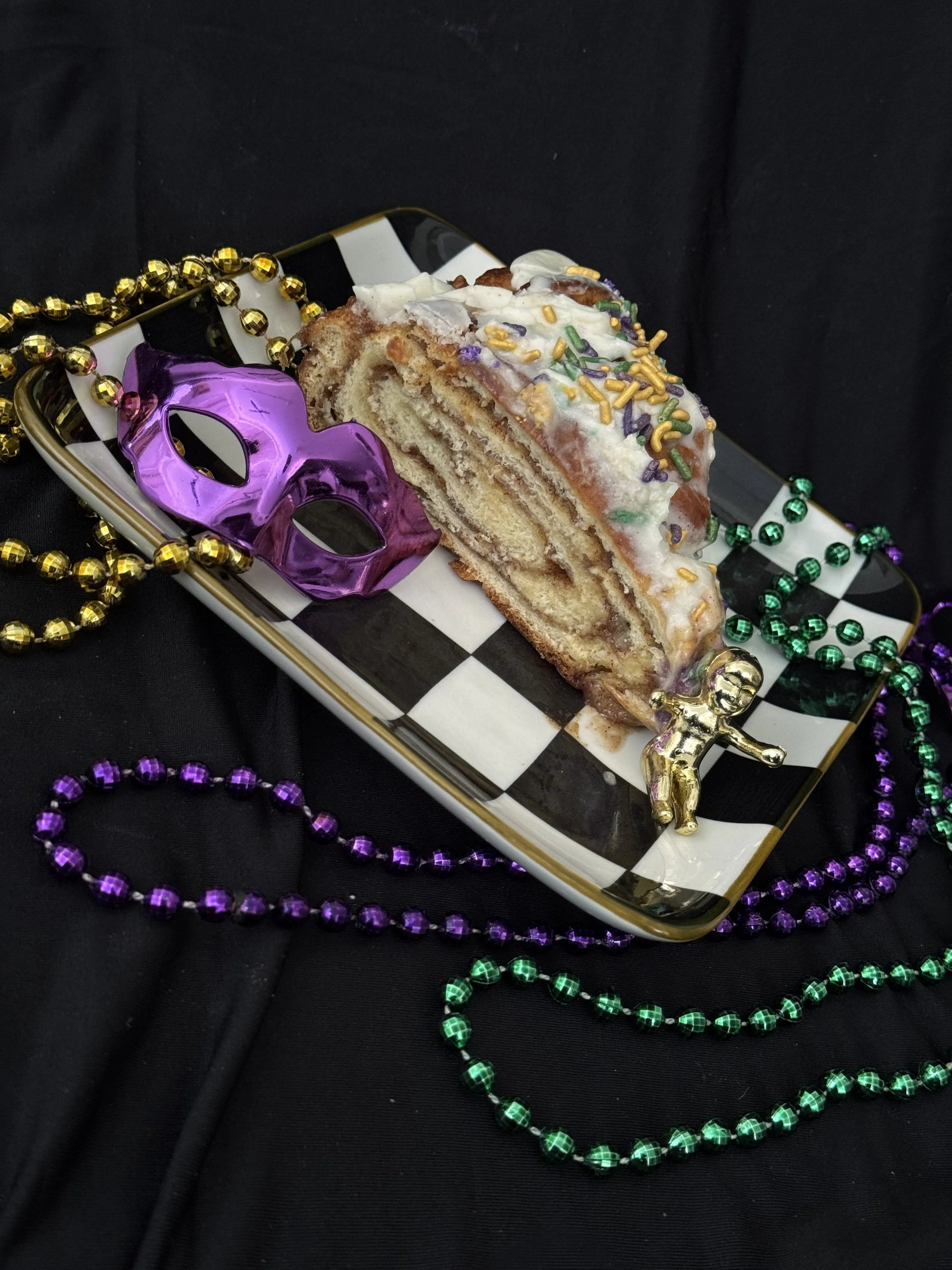 Authentic Mardi Gras king cake in Chicago from Elisa’s Cake by the Pound, featuring New Orleans-style flavor and festive purple, green, and gold sugar.