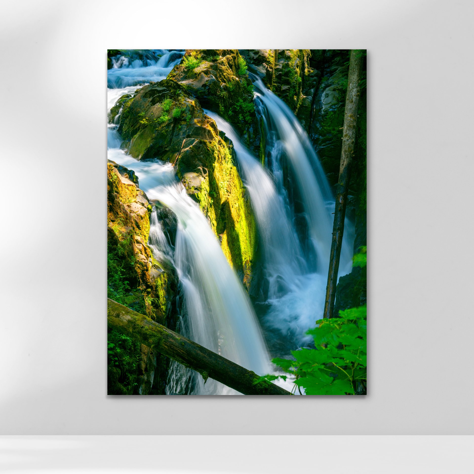 Close-up of Sol Duc Falls, water cascading over moss-covered rocks.