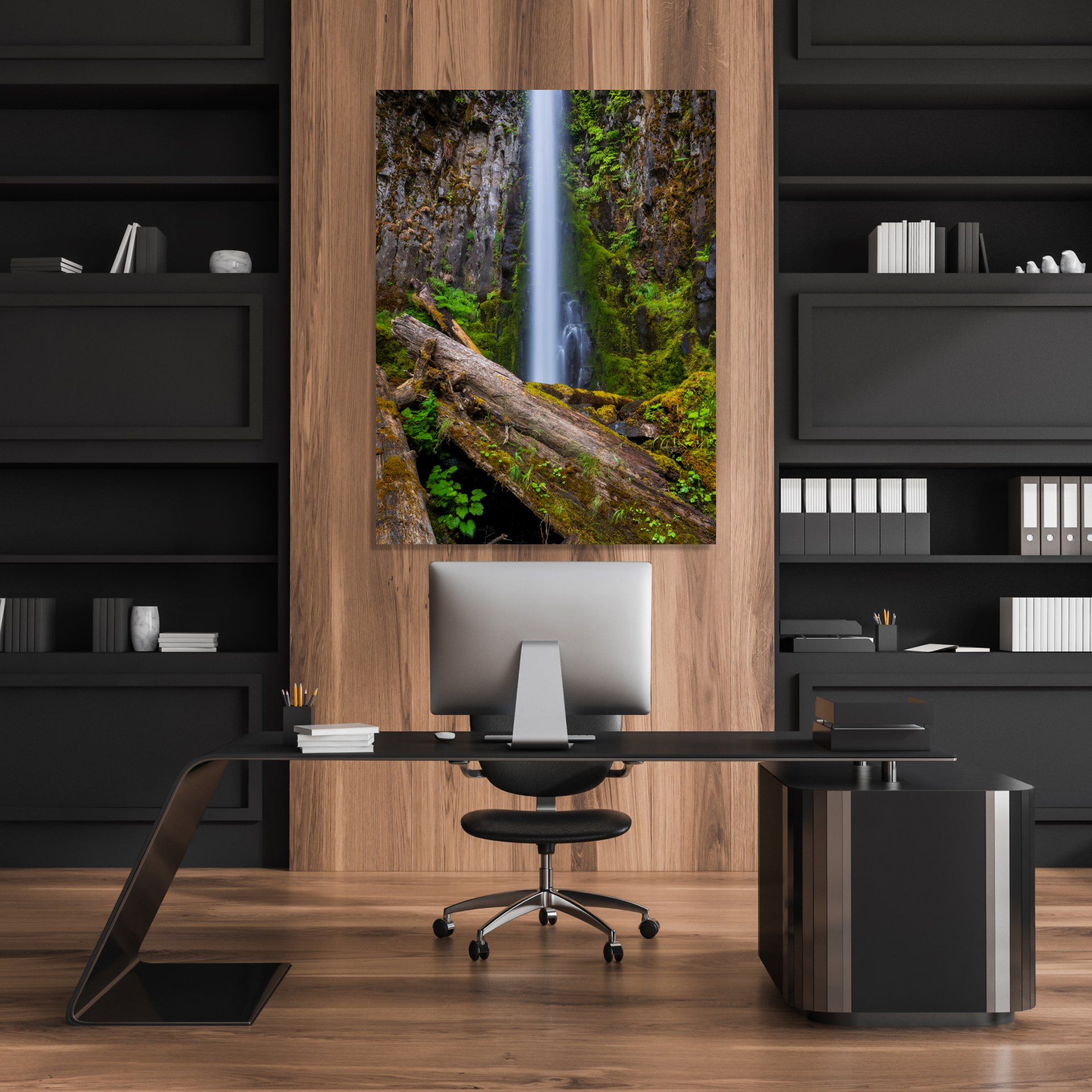 Tall waterfall cascading over moss-covered rocks, framed by fallen logs.