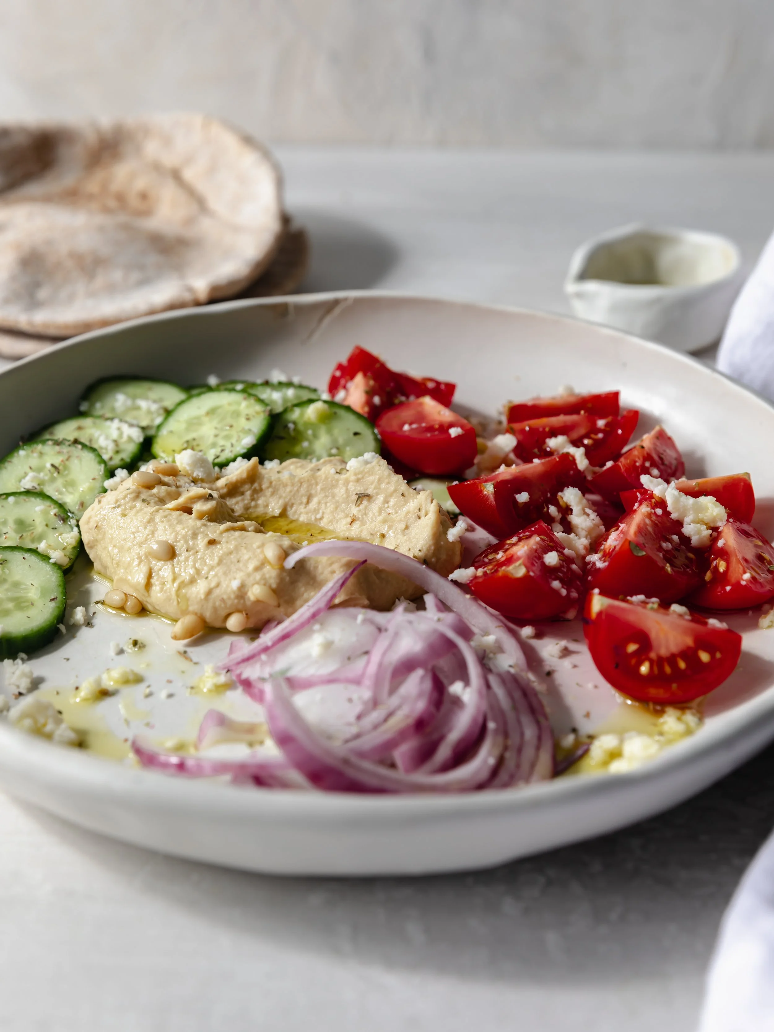 traditional greek salad with hummus and feta