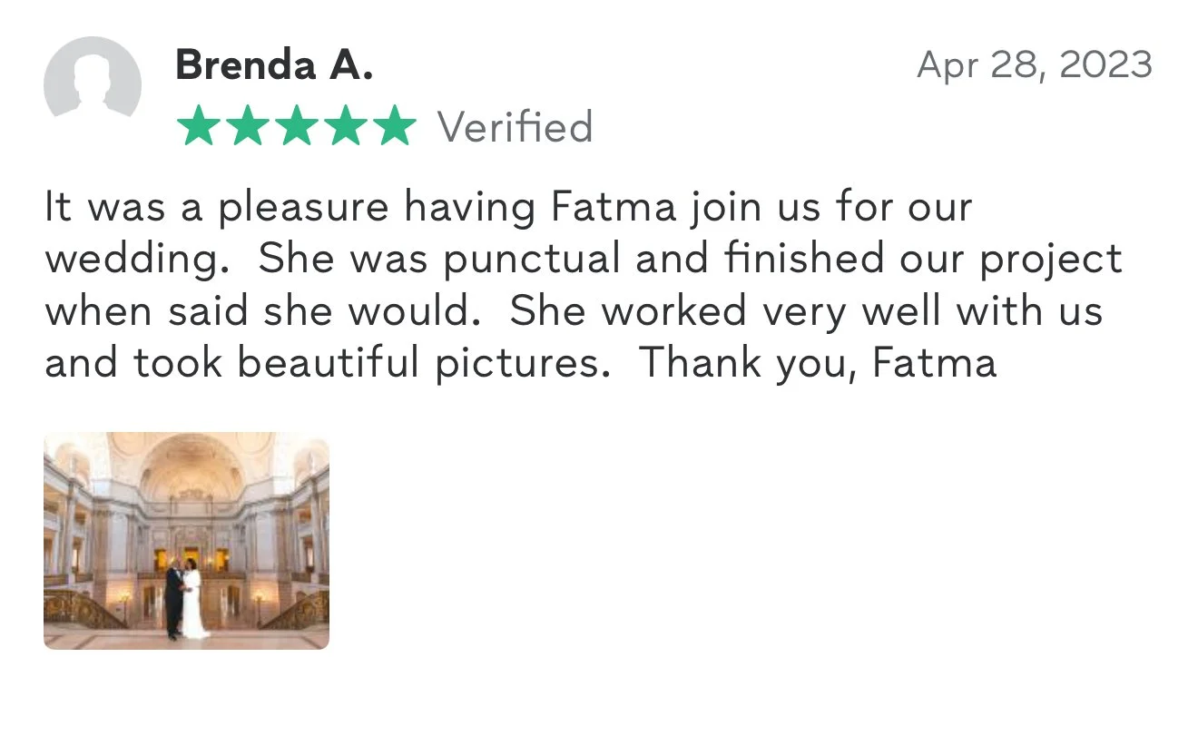 Photo of a bride and groom standing inside a grand, ornate hall with high ceilings and elaborate architecture.