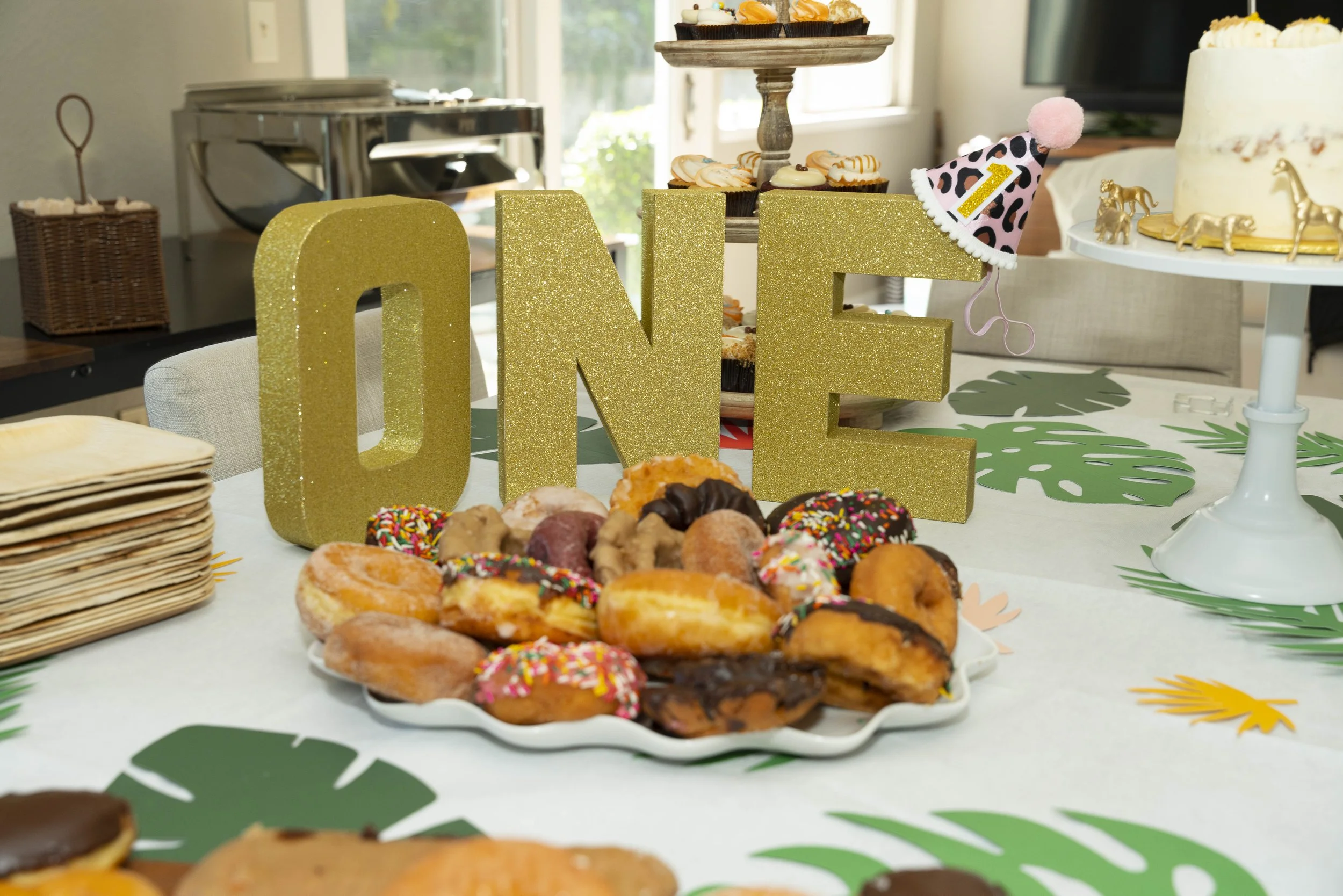 A table decorated for a celebration with a large, gold glittery 