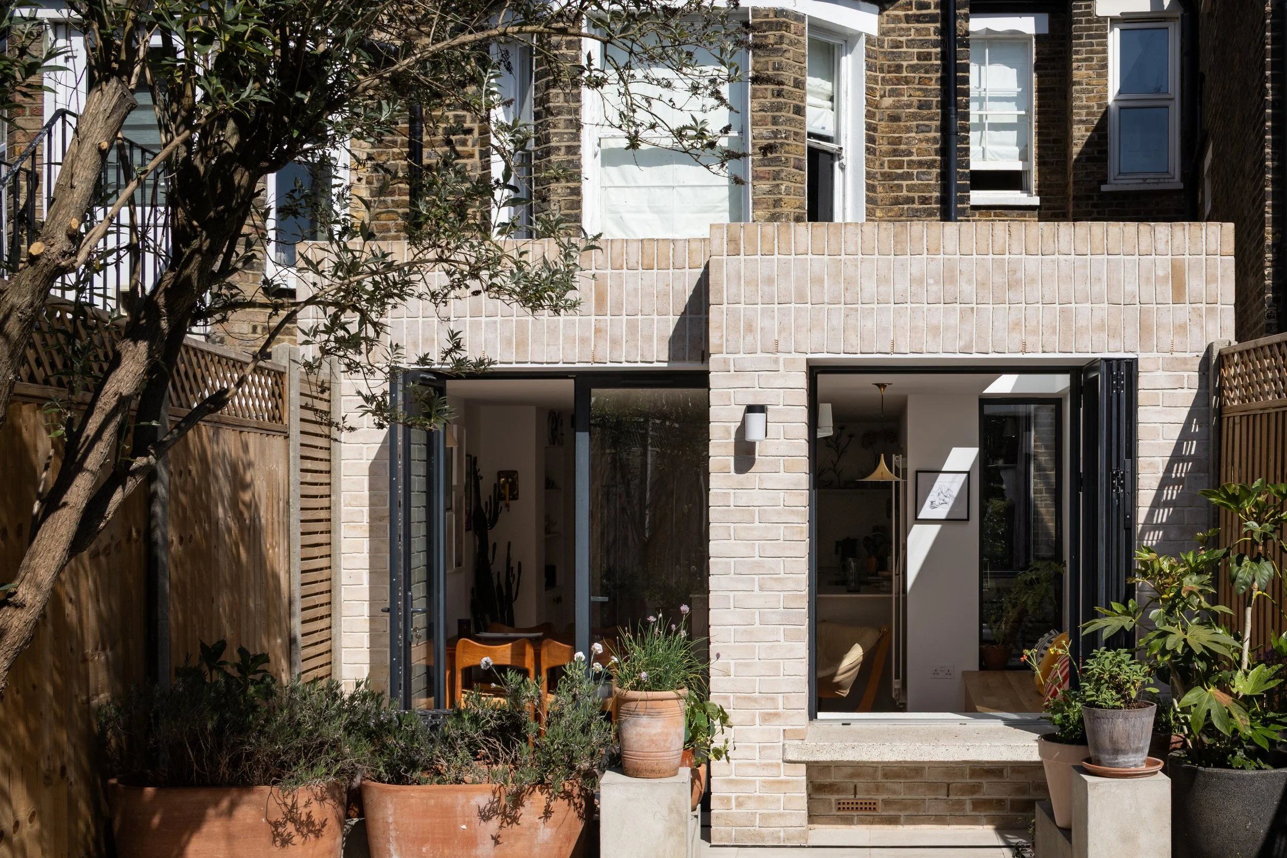 Inside-Out House, Brockley, London – Full Width Rear Extension Exterior with Terracotta Plant Pots and High Performance Glazing Bi Fold Window by Studio Manifest Architects