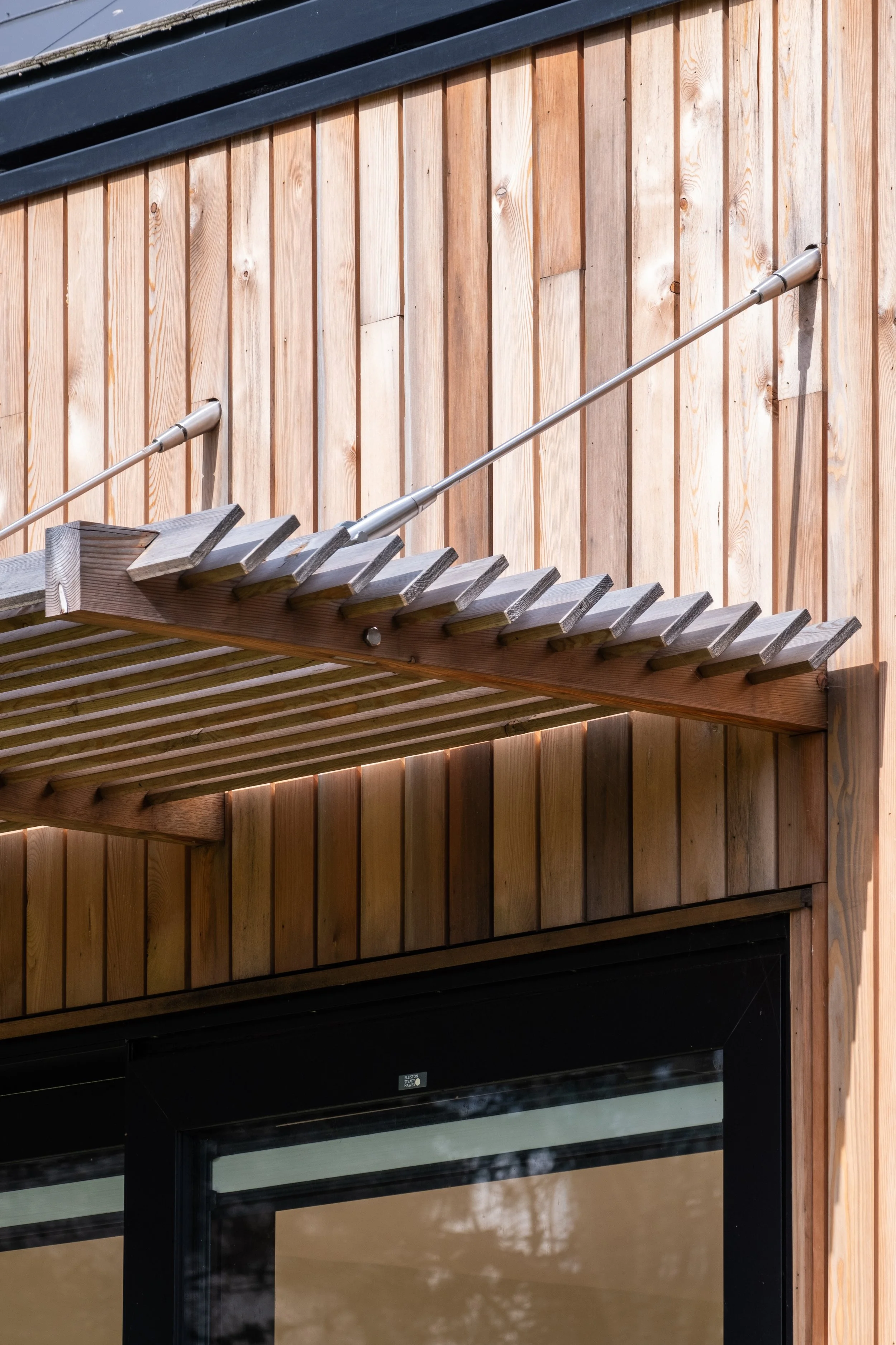 timber louvres over a window to provide solar shading temperature control