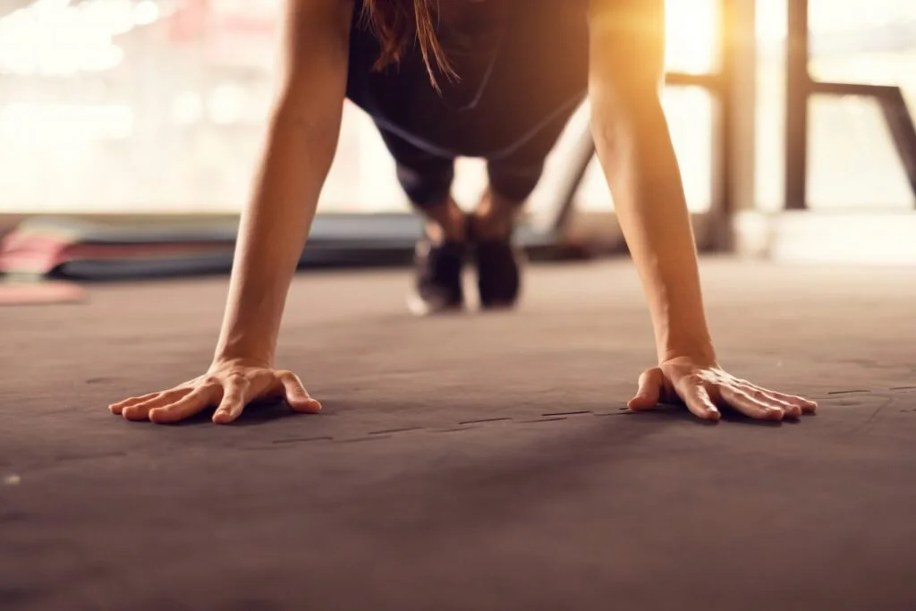 Person doing push-up exercise on a gym floor