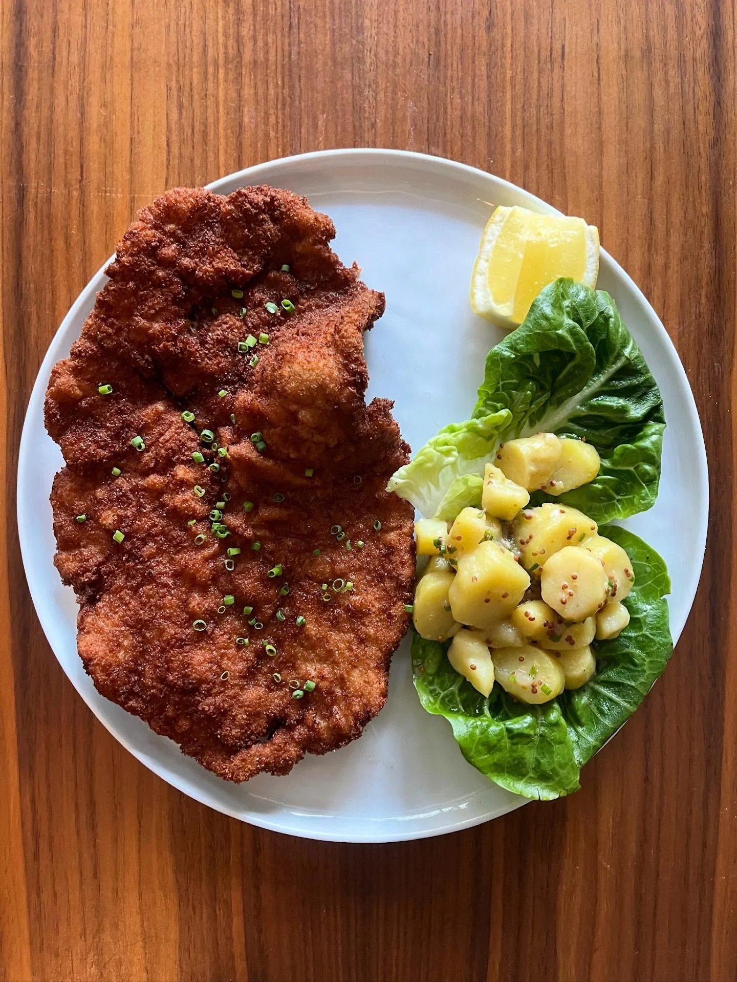 In honor of Oktoberfest happening right now in Germany, why not stop in for our signature Wienerschnitzel &mdash; a golden, crisp veal cutlet served with warm German potato salad, fresh butter lettuce, and a bright squeeze of lemon. The perfect bite 