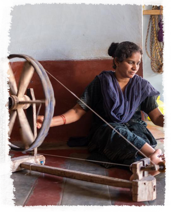 They are experts in achieving the fine balance of twist and draw to produce a variety of low/high twists and thick/thin yarn. The women use the charkha to spin. The rhythmic rotation of the charkha accompanied by the nimble draw of fibres is meditati
