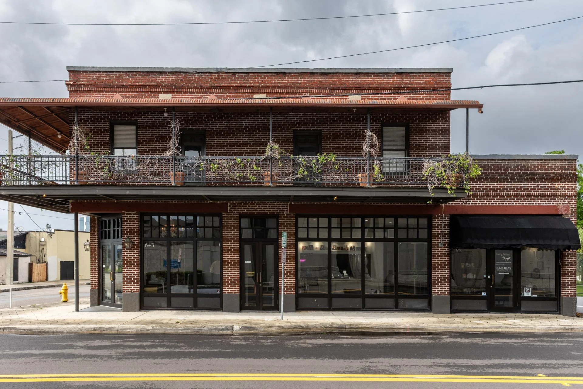Historic brick storefront of Julie Ryan Photography at 635 Edison Ave, Jacksonville FL—inviting luxury headshot, senior portrait, and boudoir clients to an upscale studio experience.