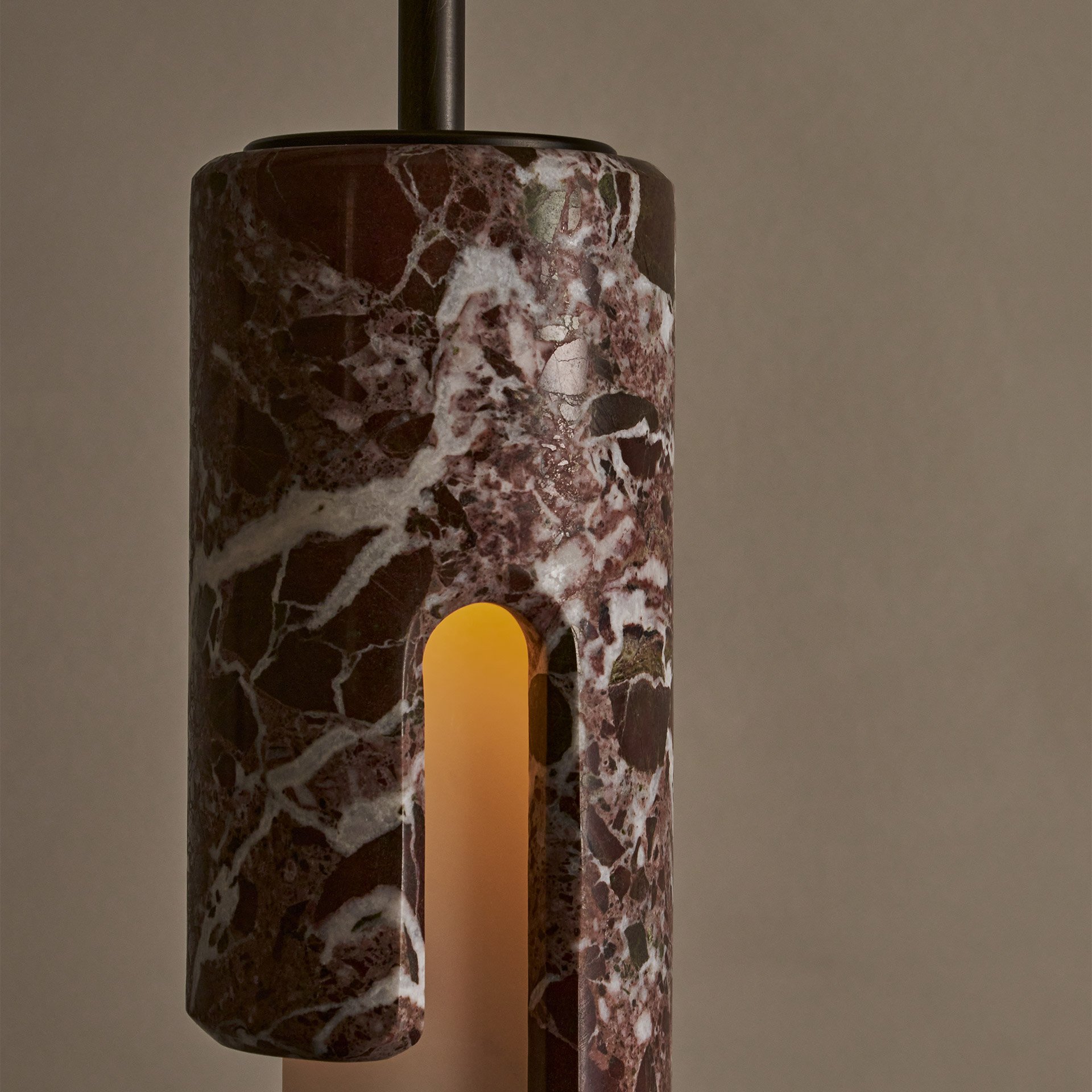 The Dover ceiling pendant features hidden fastening, seamlessly blending stone and glass components. Its cylindrical shade reveals an asymmetric profile from the side. (Copy)