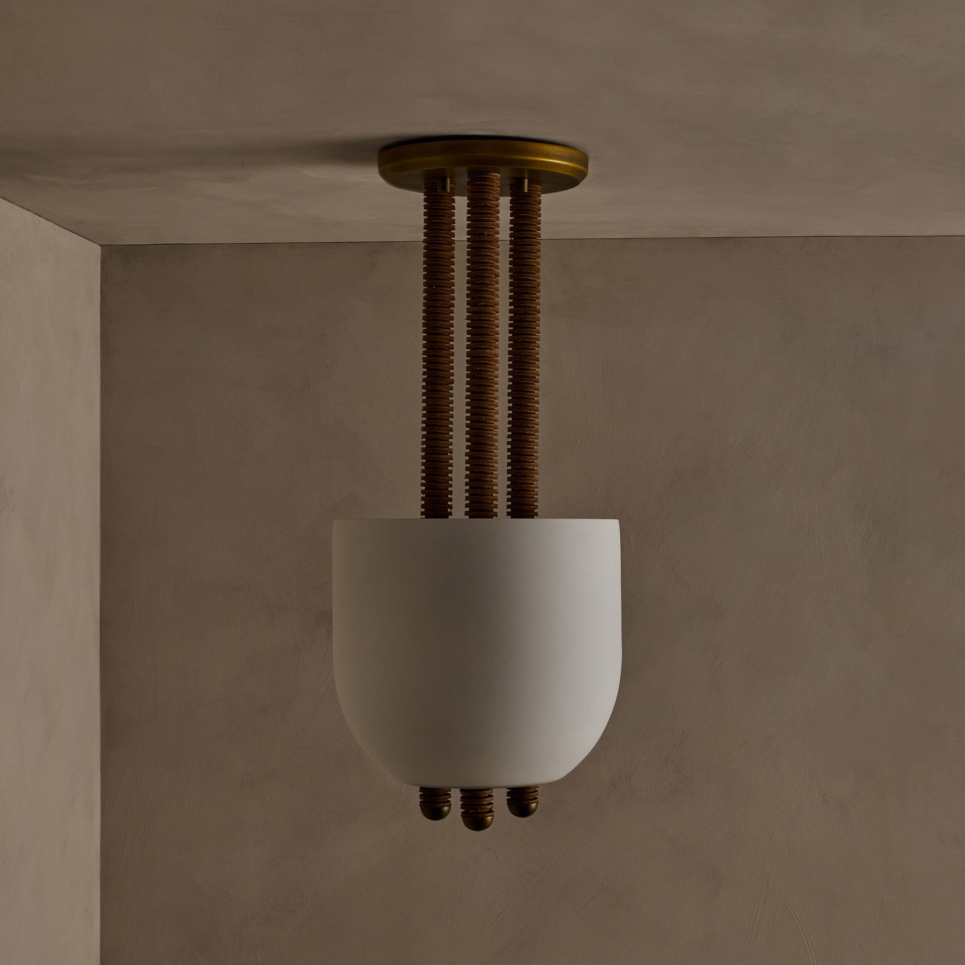 The Folton fixture showcases stacked leather hide disks, celebrating natural imperfections. A frosted glass shade illuminates the leather's edge while supports create a seamless union of components.