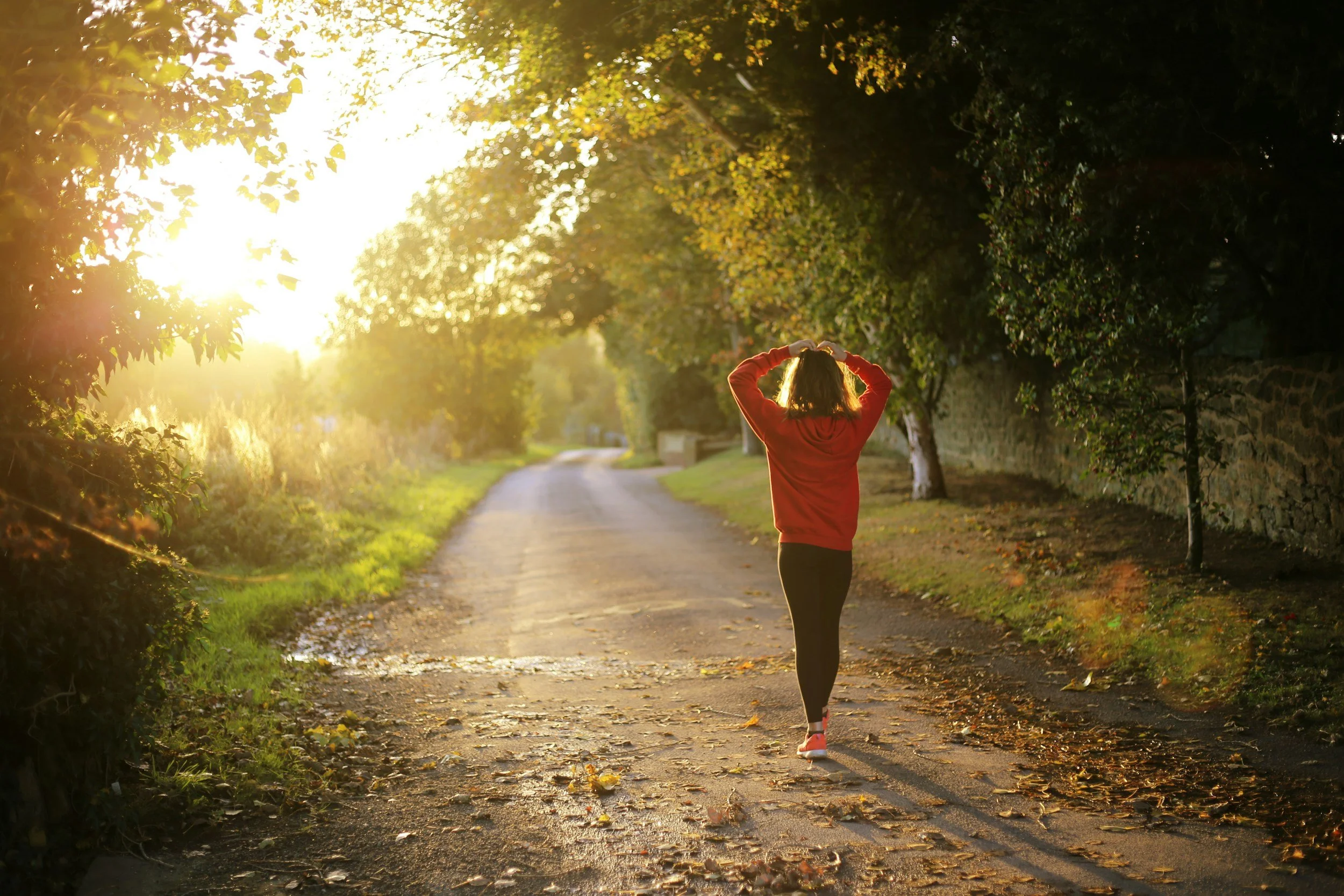 Health conscious woman on a path, in the morning sun, outdoorsalth anxiety