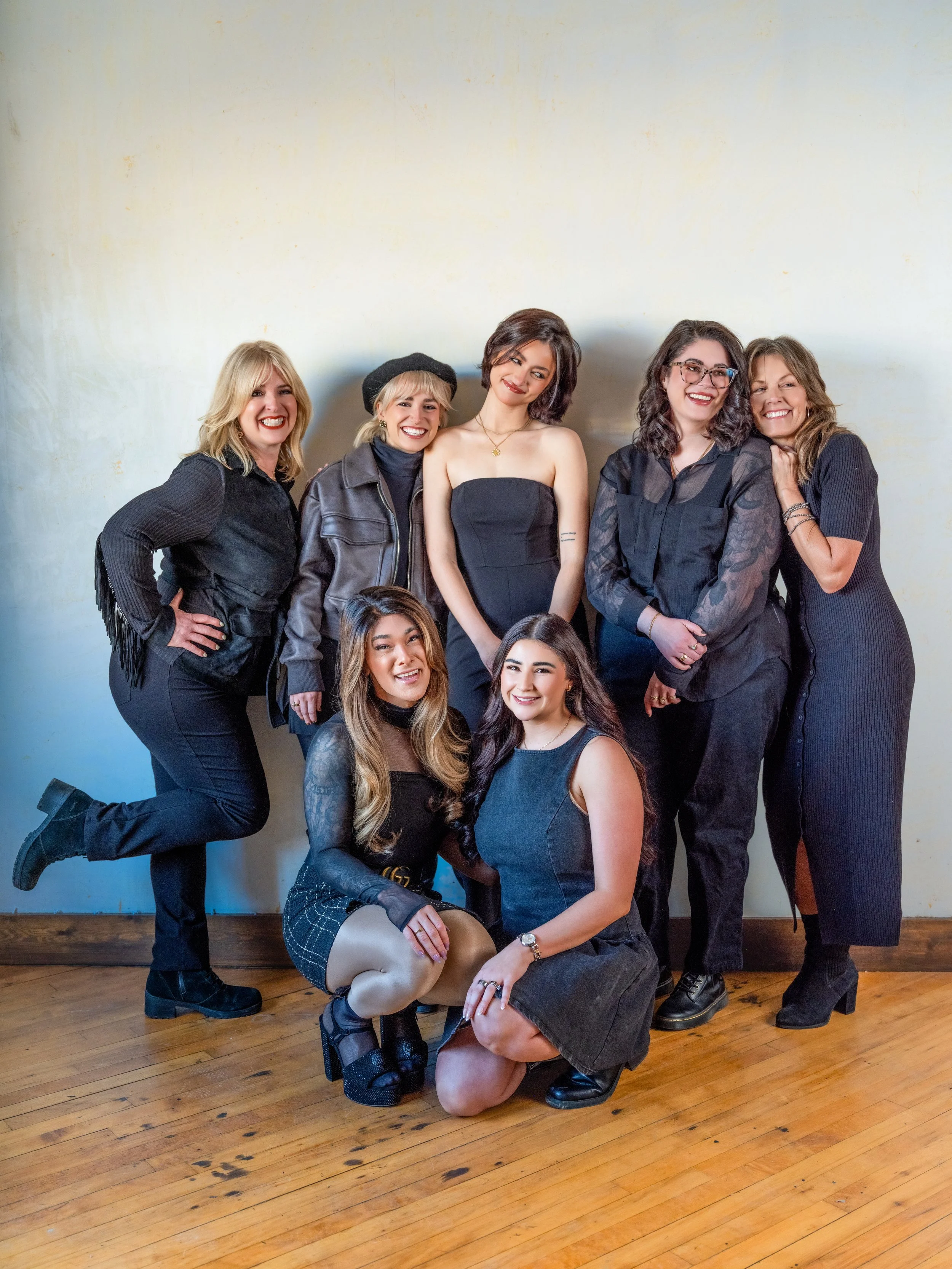 Dramatic editorial branding portrait of a Louisville hair and makeup artists with contrast lighting and bold expression.