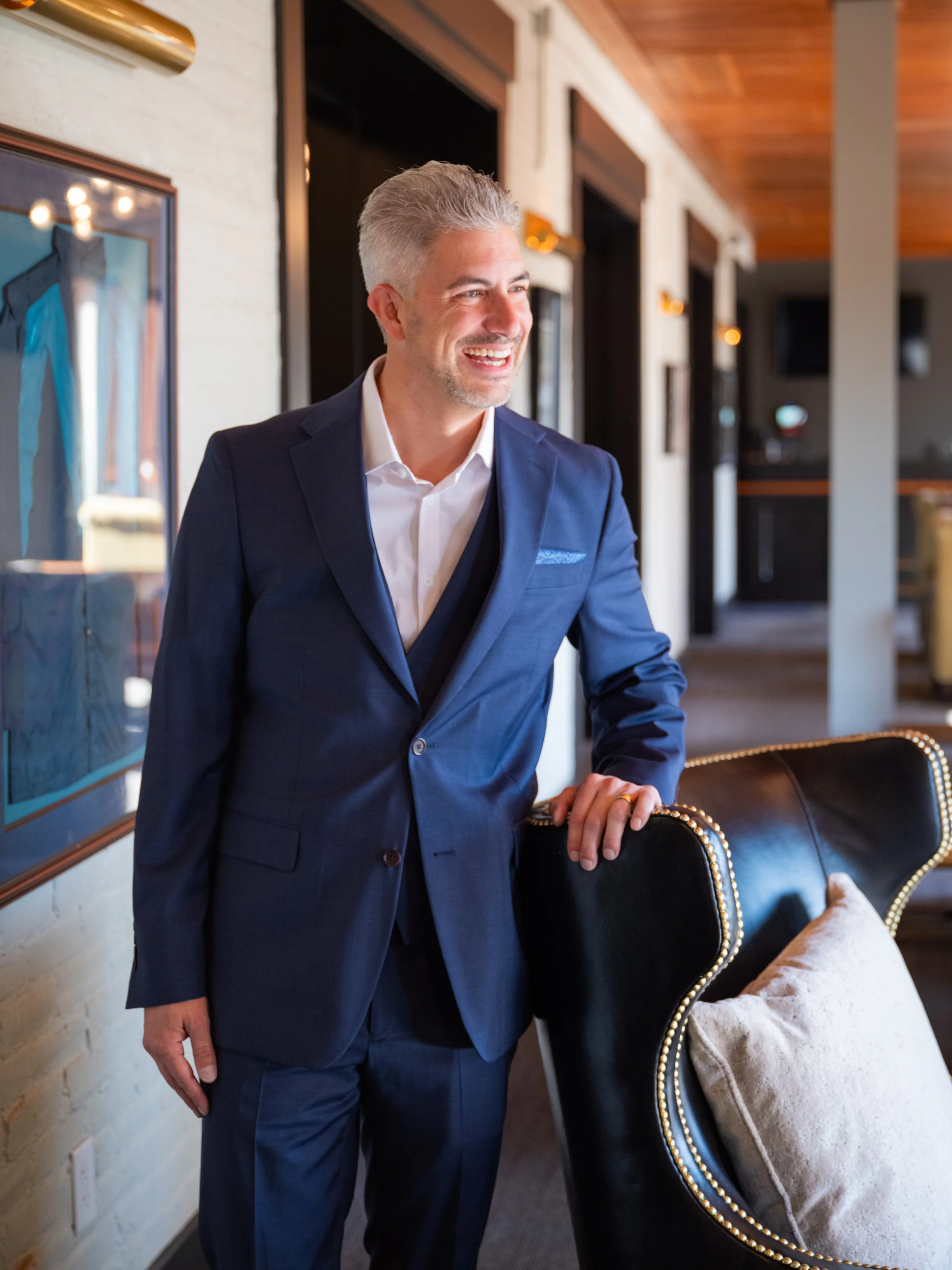 Professional branding photo of man in tailored blue suit at historic Louisville Thoroughbred Club.