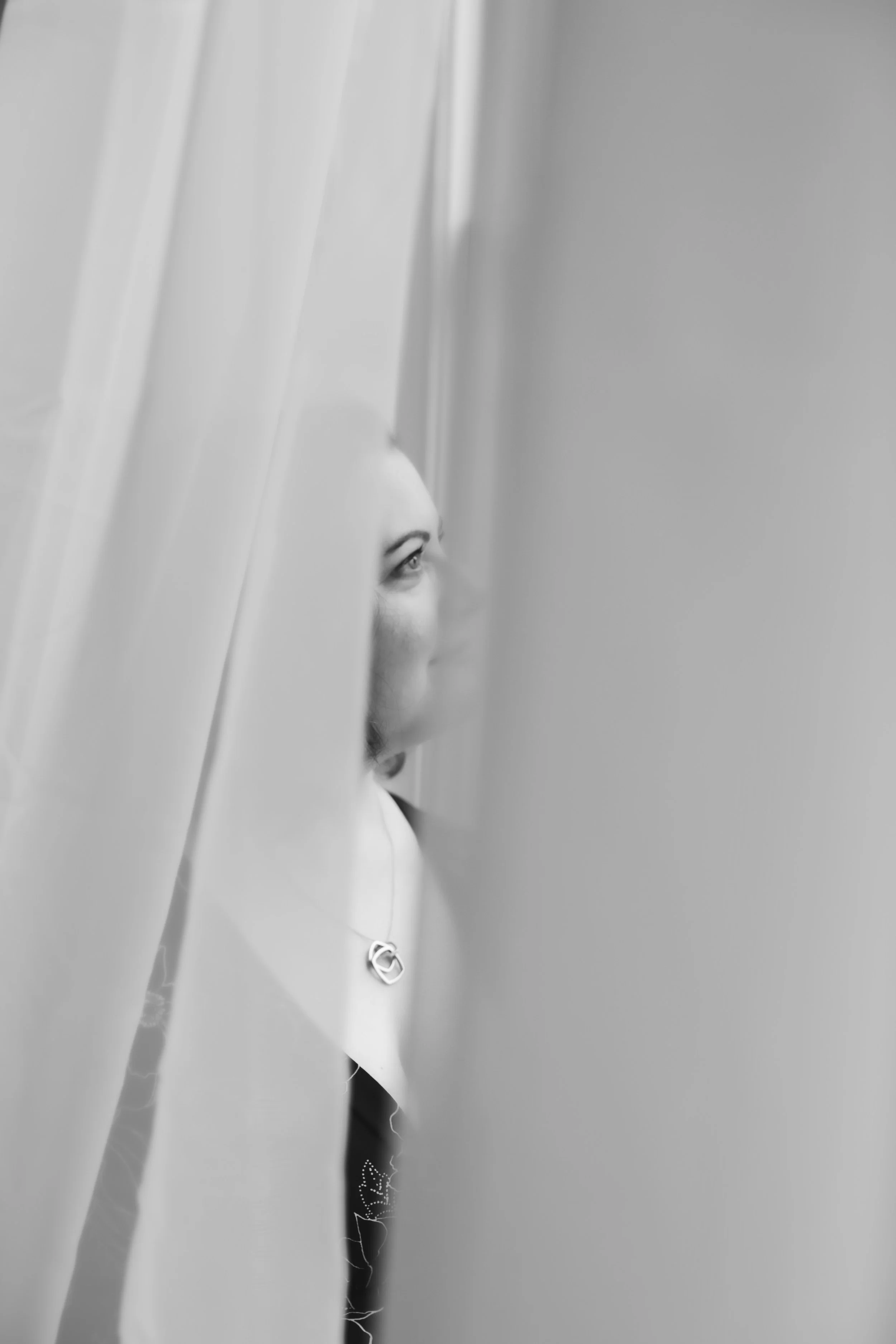 gauzy image of a woman behind a white curtain