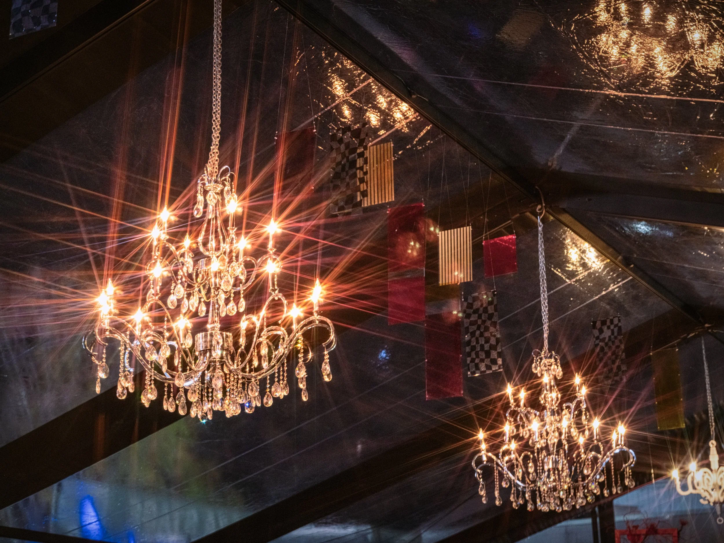 Crystal chandelier inside the Epicurean Village tent at REV Indianapolis 2026 photographed by Jama Finney event and culinary photographer
