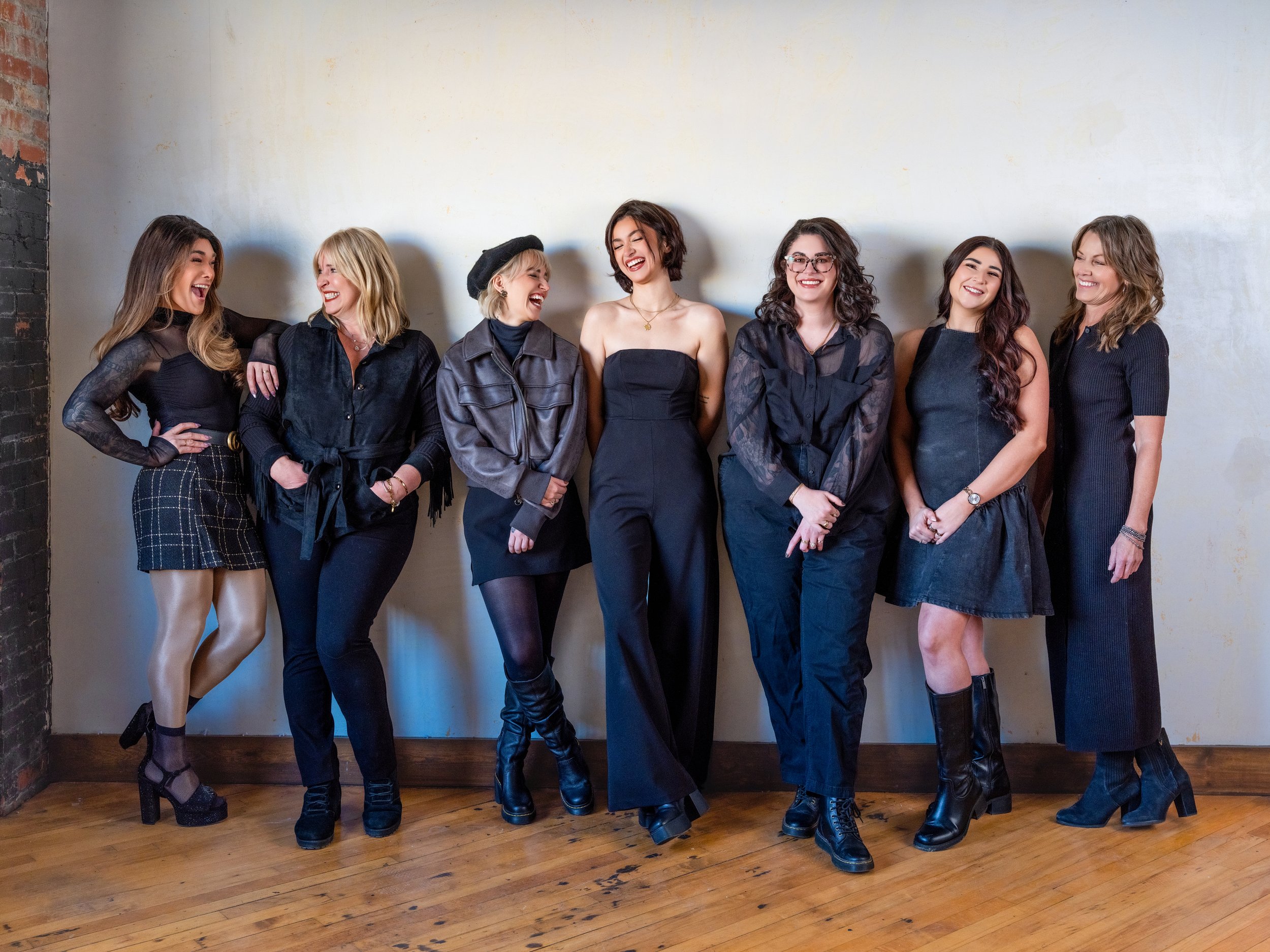 Dramatic editorial branding portrait of a Louisville hair and makeup artists with contrast lighting and bold expression.