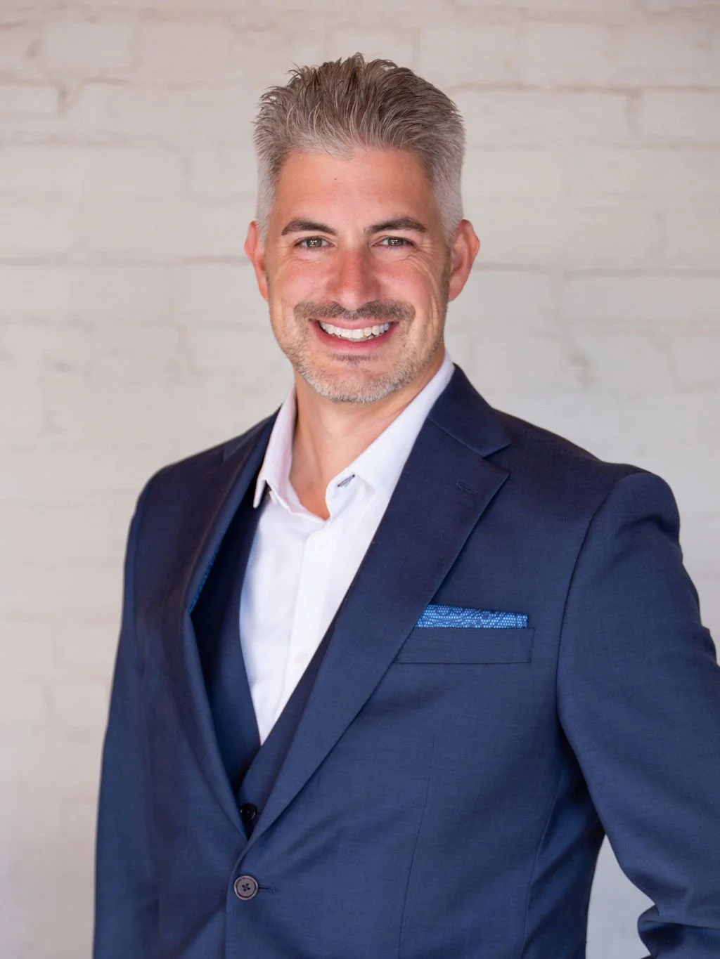 Close-up professional headshot featuring natural light, expressive eyes, and a clean, editorial-style backdrop.
