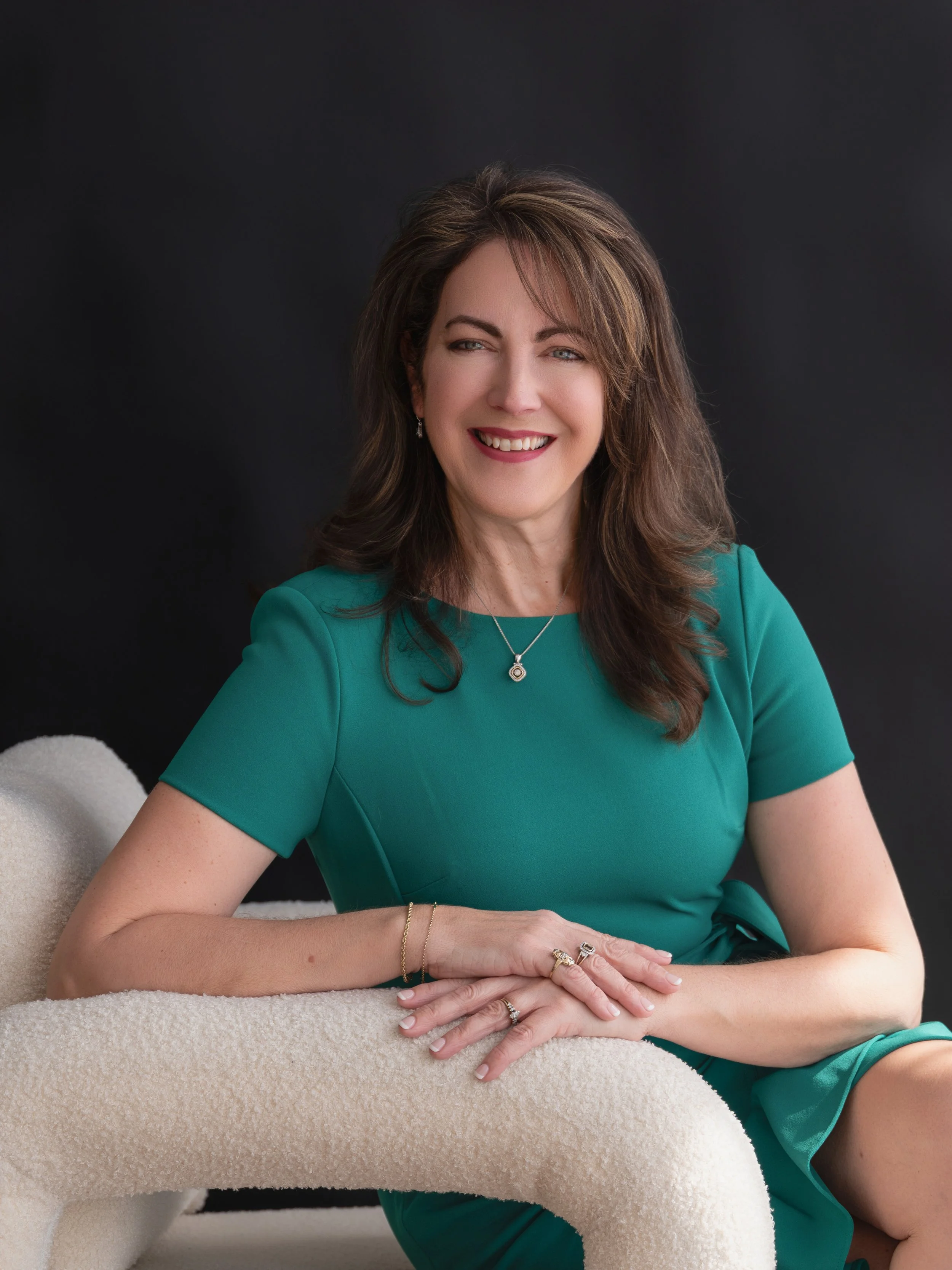 Minimalist professional headshot photographed on a seamless backdrop with modern editorial lighting.