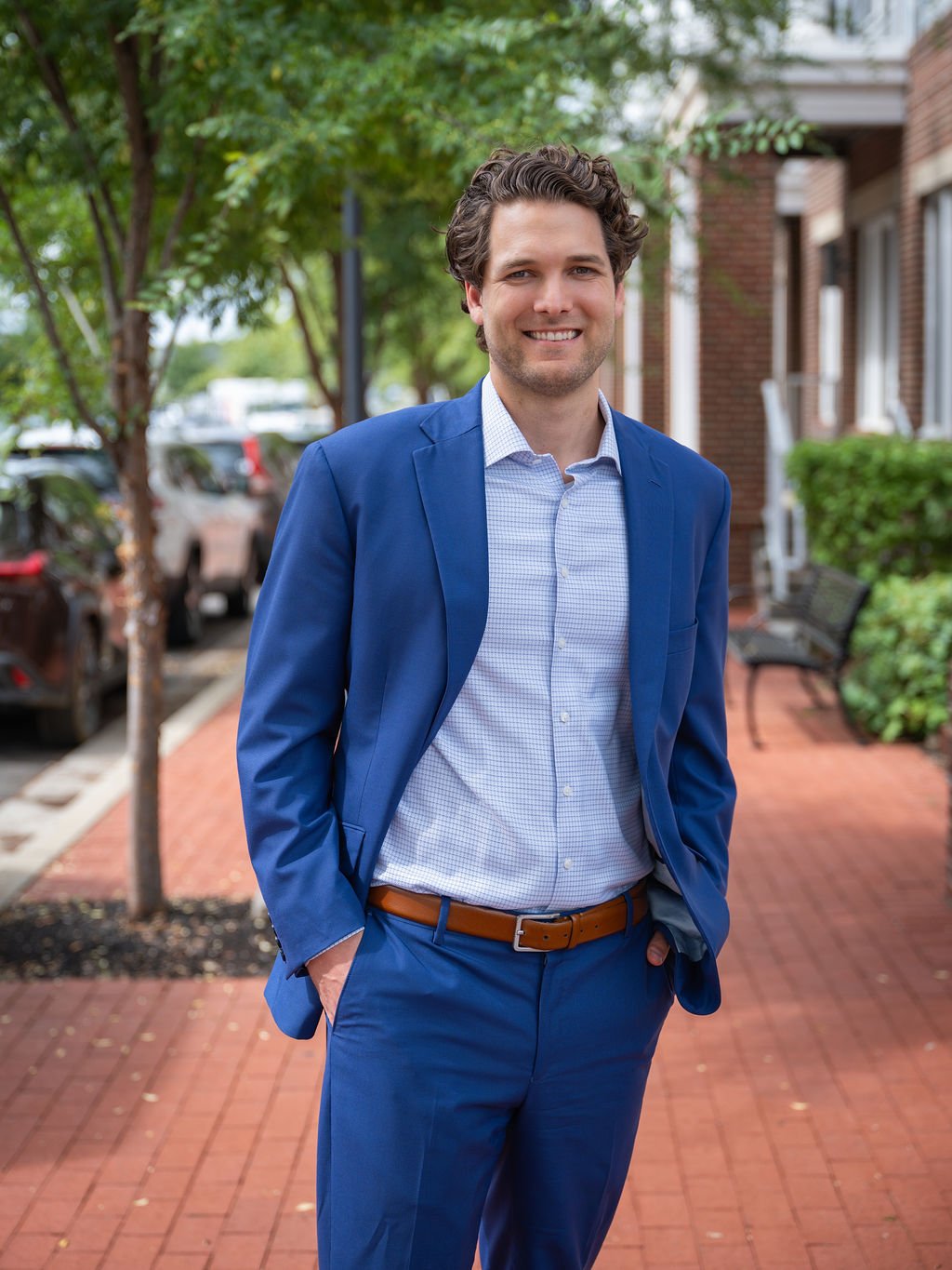 Outdoor headshot captured in Louisville with natural backlighting and a fresh, approachable expression.