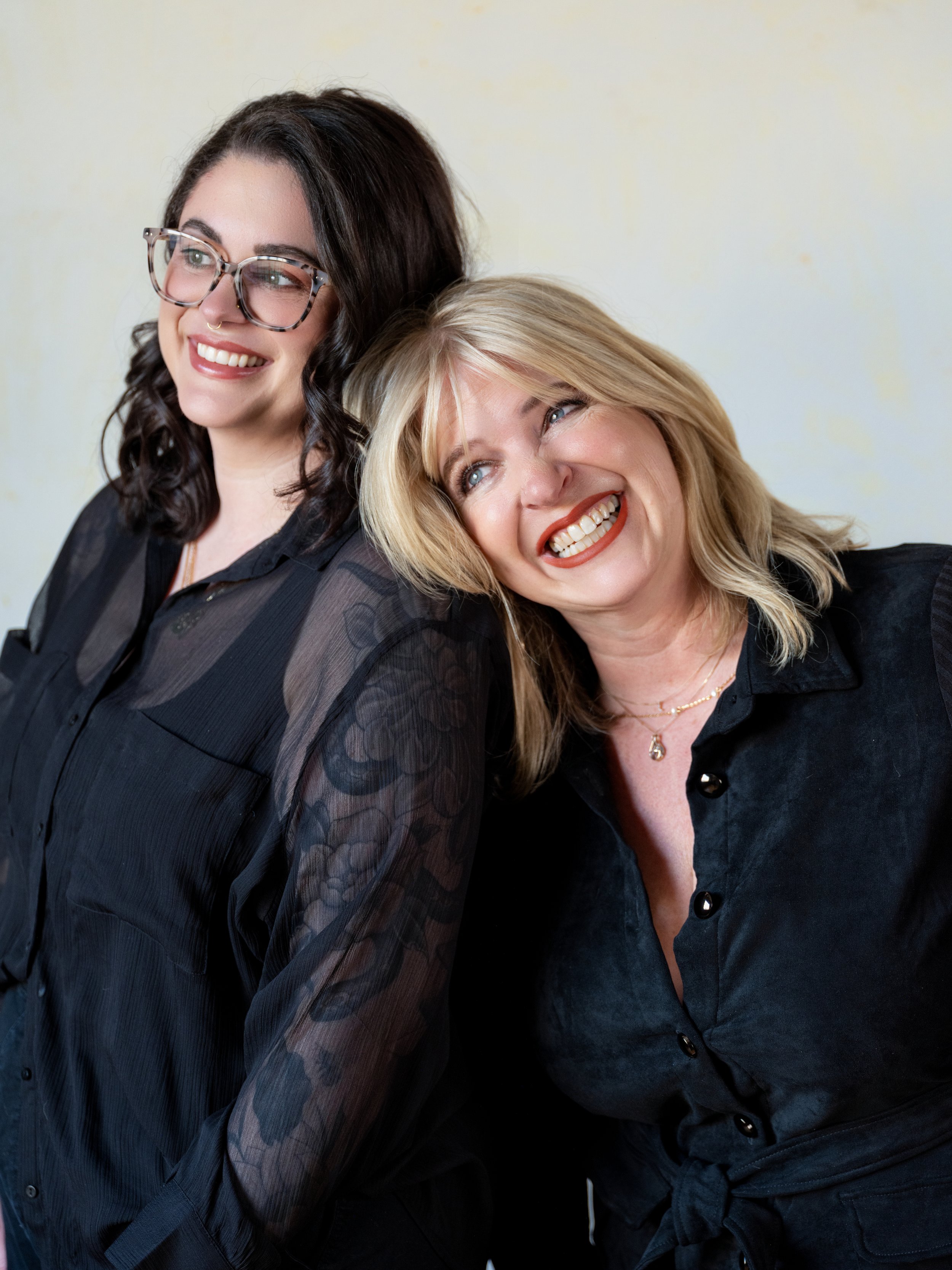 Dramatic editorial branding portrait of a Louisville hair and makeup artists with contrast lighting and bold expression.