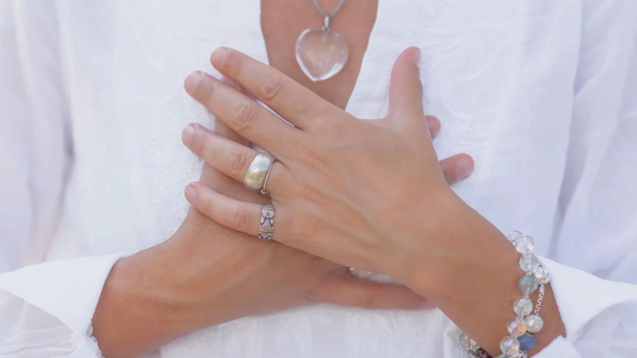 A person crossing their palms over their chest.