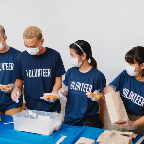Volunteers making sandwiches.