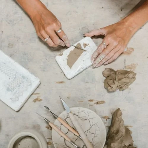 A person making something with clay.