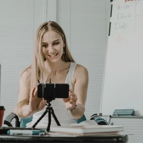 A person talking to a camera on a tripod.