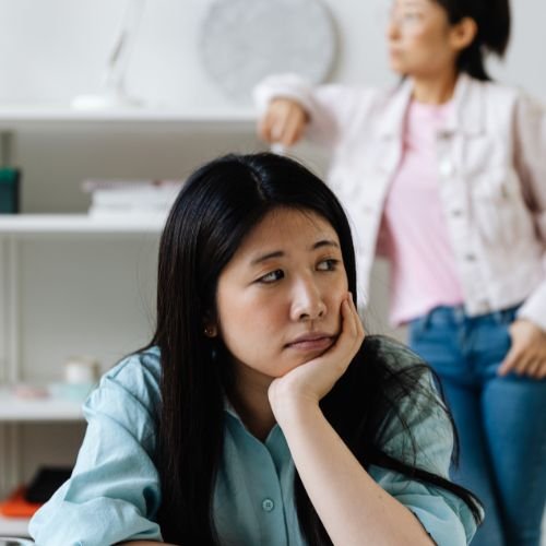 Two women, looking bored.