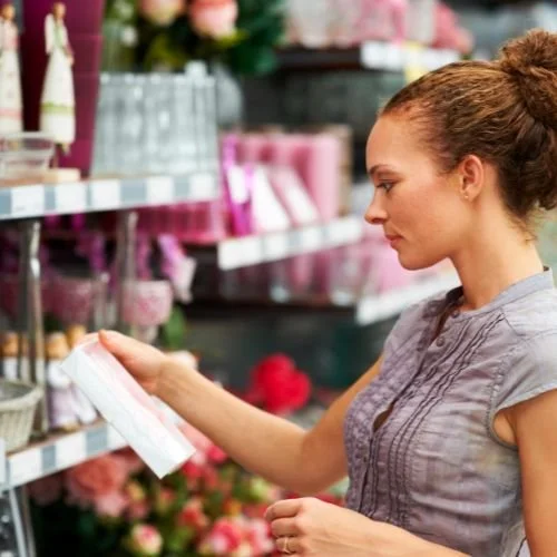 A person placing a product onto a display shelf.