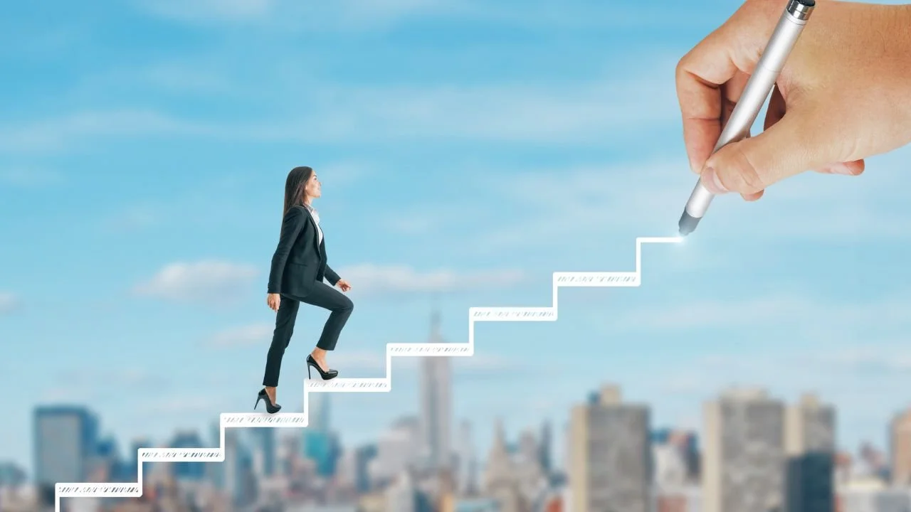 A person in a suit climbing a series of steps into the sky.