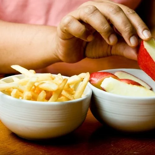 apple and french fries in two bowls