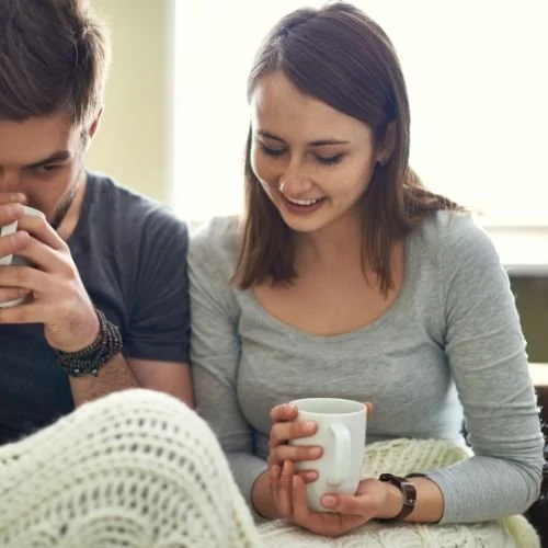 A young couple having coffee together
