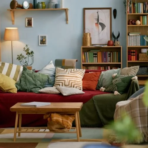 An eclectic collection of furniture, art and books in a living room.