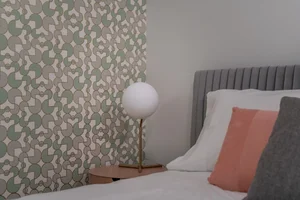 The bed in the Vibe suite with a patterned accent wall