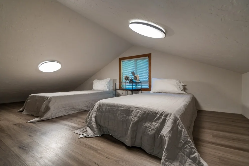 The loft with two twin beds under the sloped ceiling