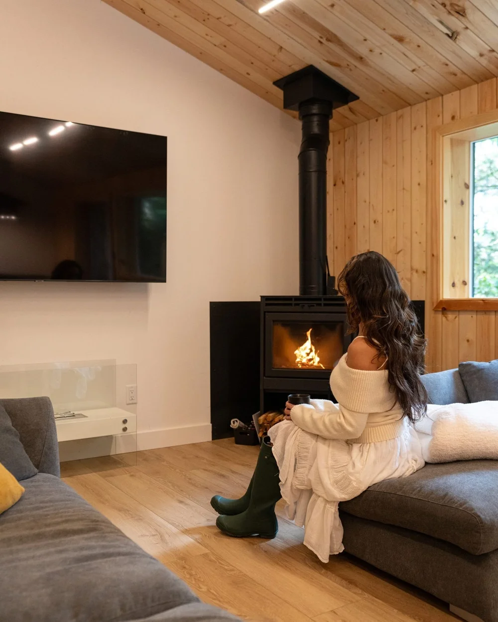 Living room with a big TV and the fire going