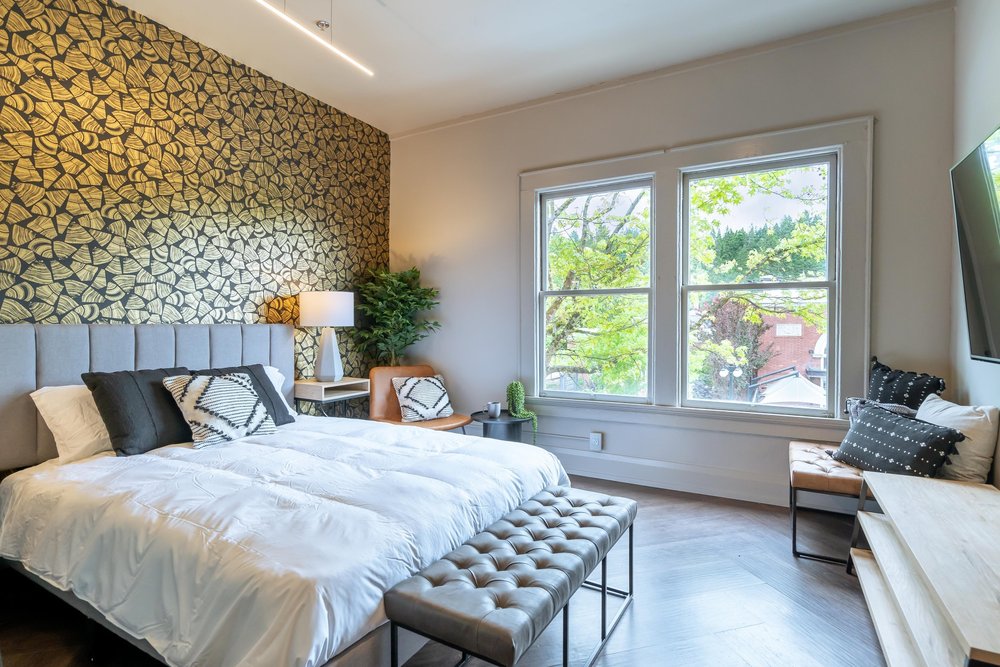 The SoHo suite, a queen bed under a patterned feature wall